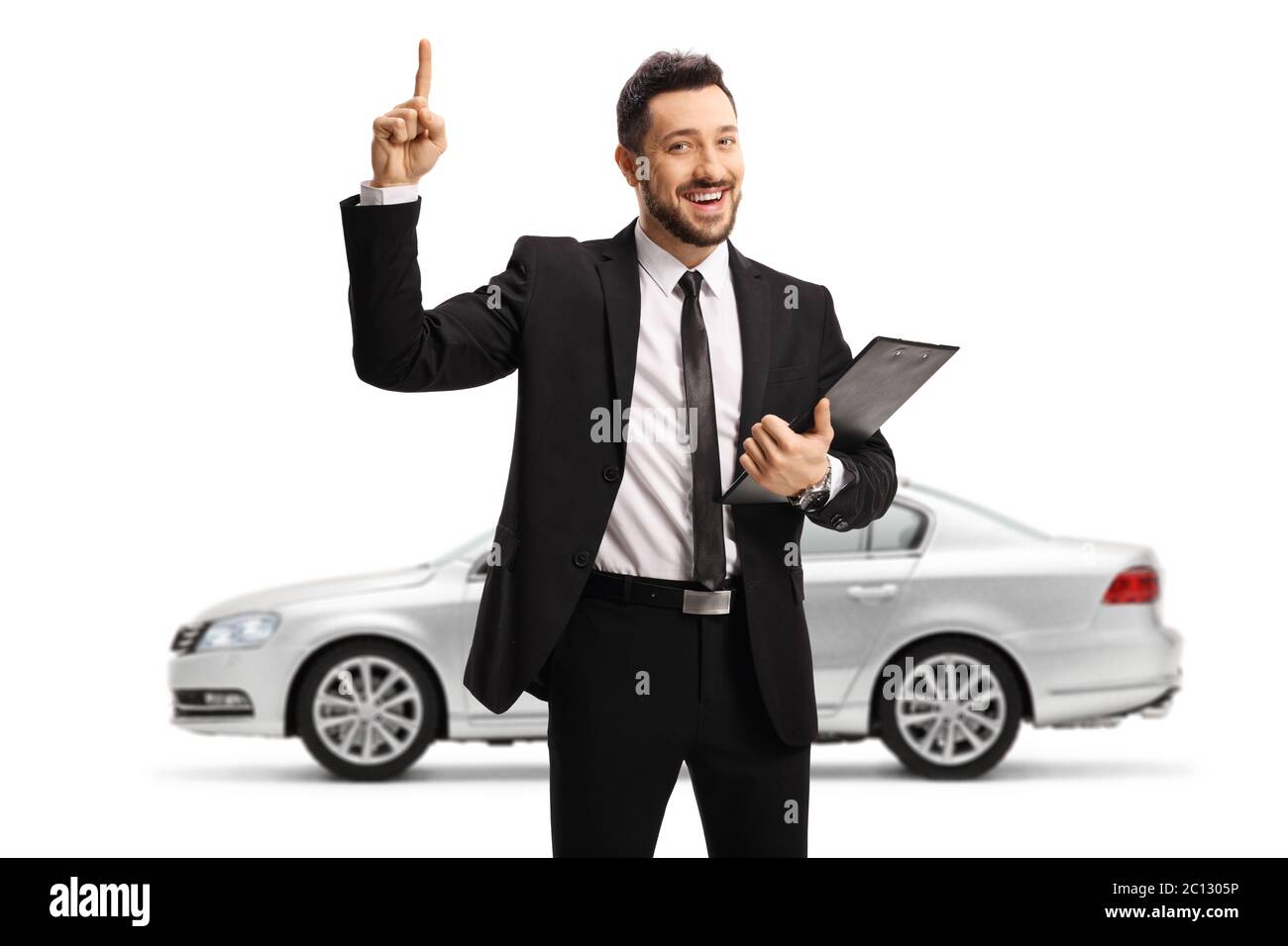 Car salesman standing in front of a silver car and pointing up isolated