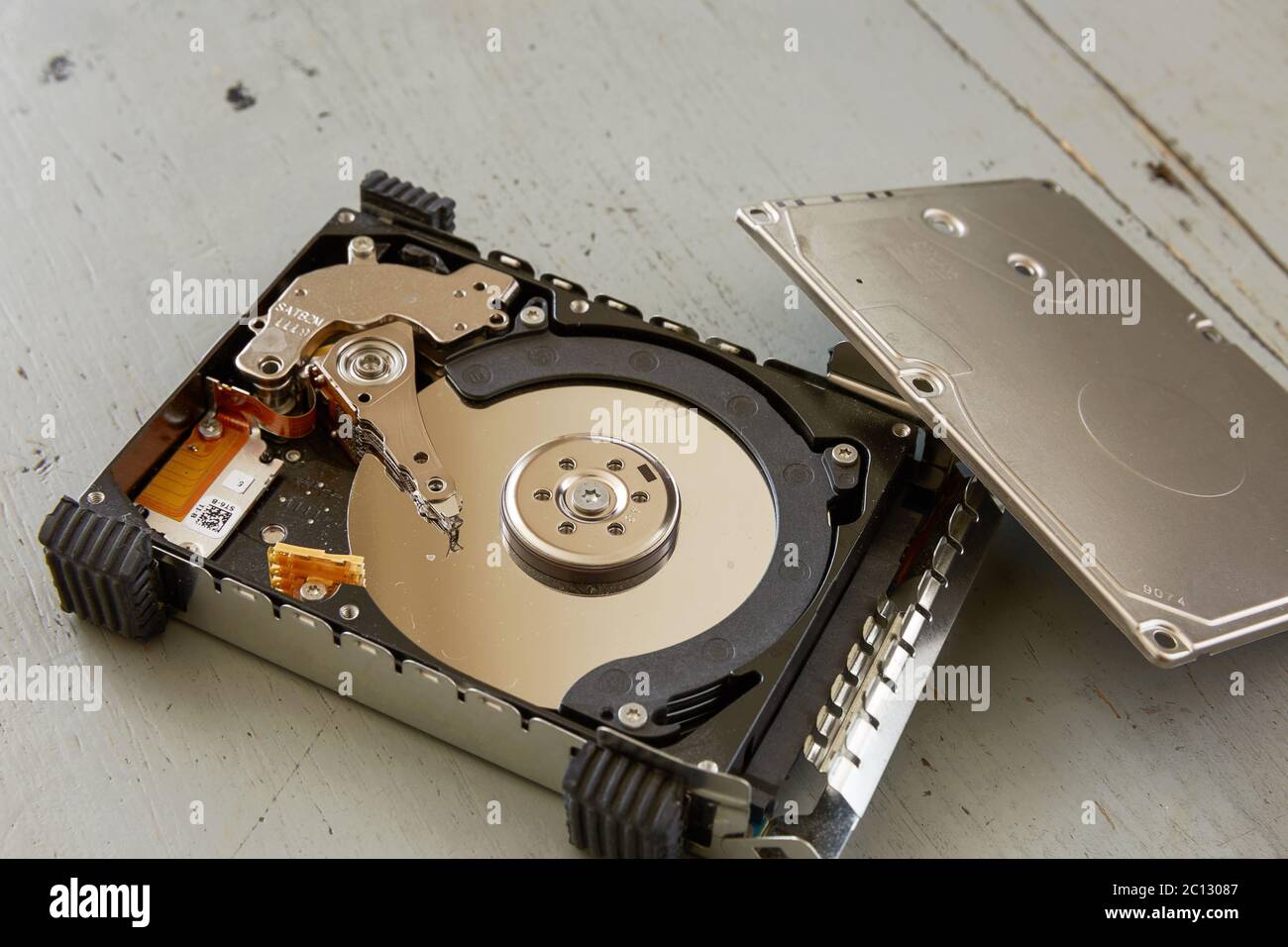 Close Up of Broken and Destroyed Hard Drive Disk on Wooden Table Stock Photo
