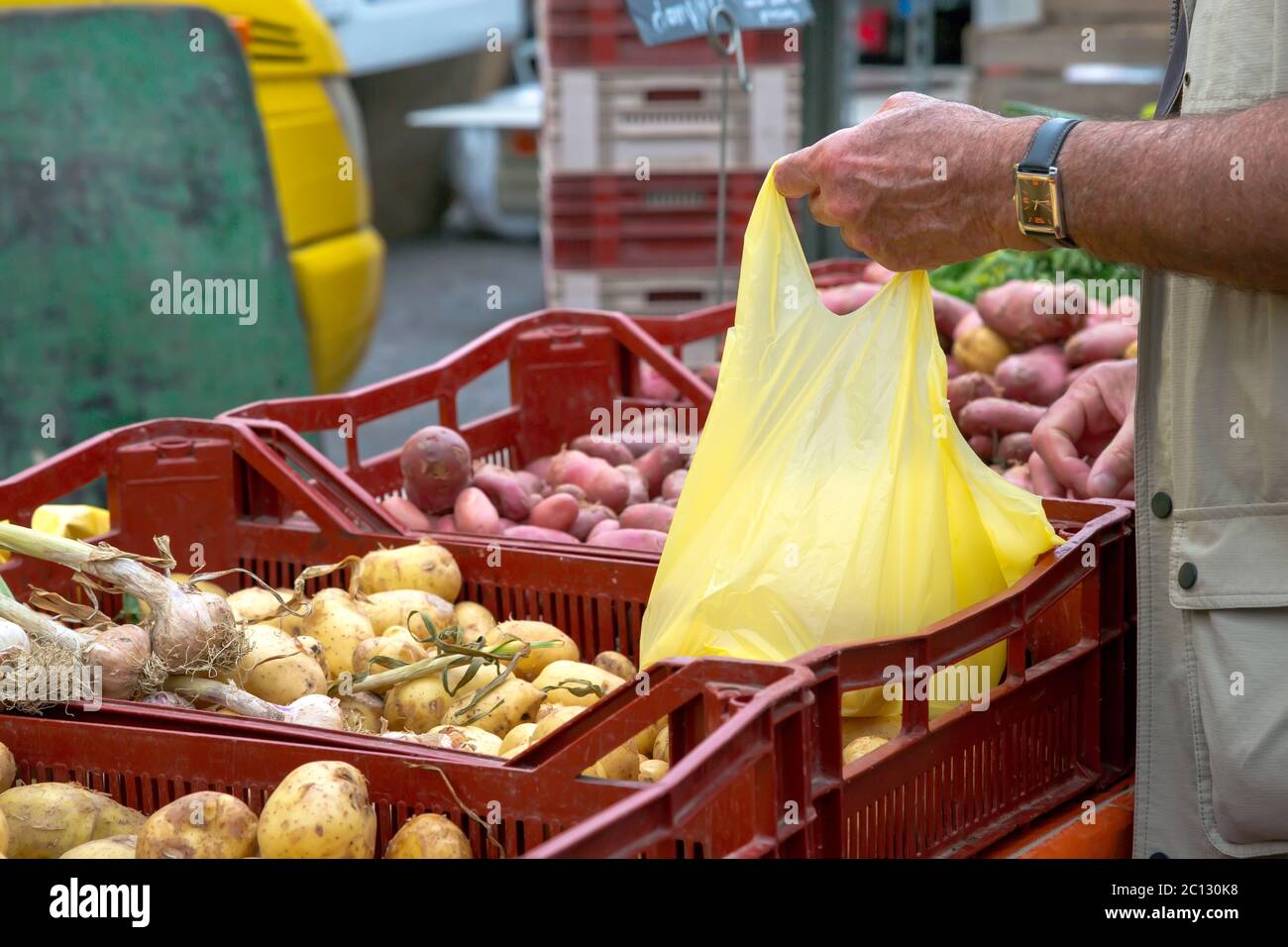 man buying new potatoes from local market Stock Photo