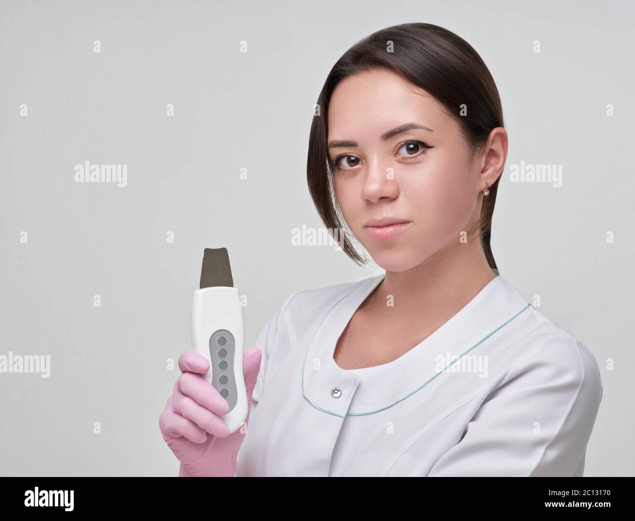 Doctor taking ultrasonic cleaning device. Acian looking woman in