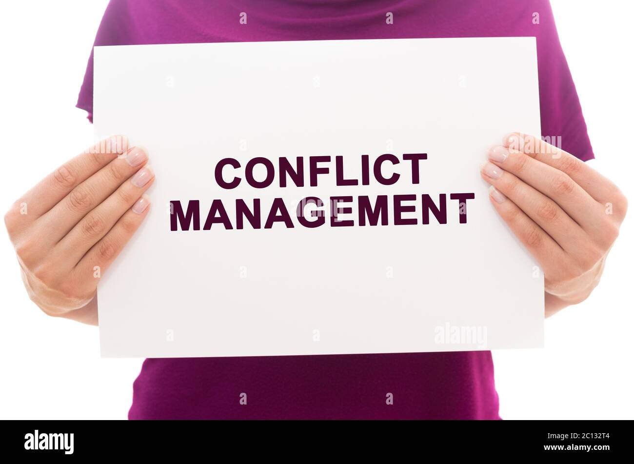 Girl holding white paper sheet with text Conflict management Stock Photo