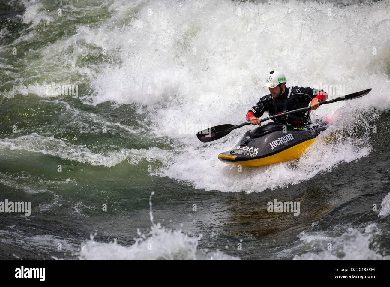 Male freestyle kayaker kayaking on the River Nile at the Nile River