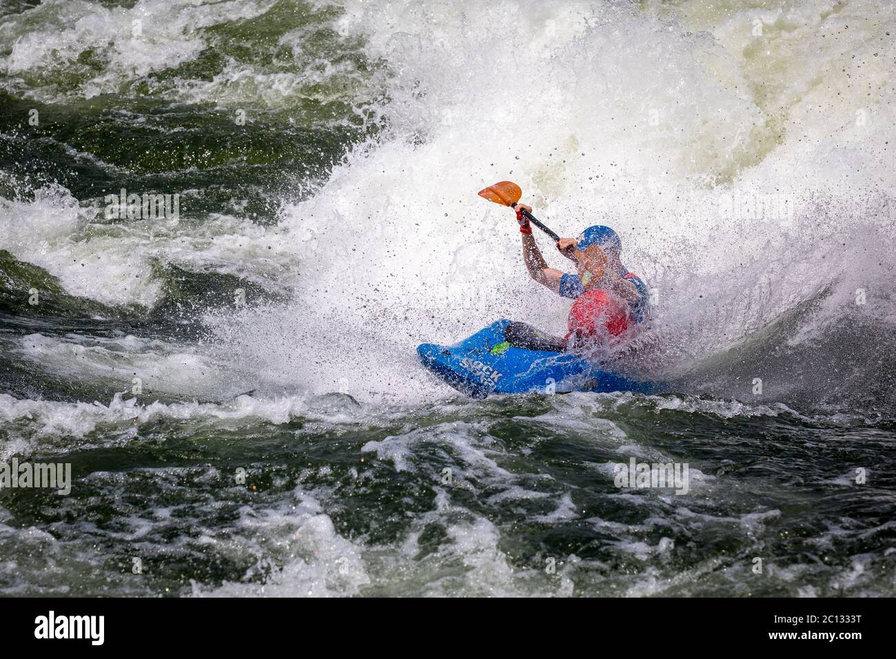 Male freestyle kayaker kayaking on the River Nile at the Nile River