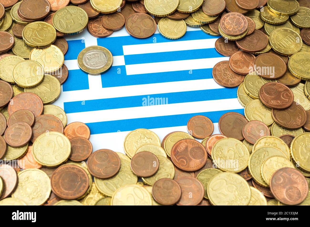 Euro coins placed on paper sheet with printed Greece flag Stock Photo