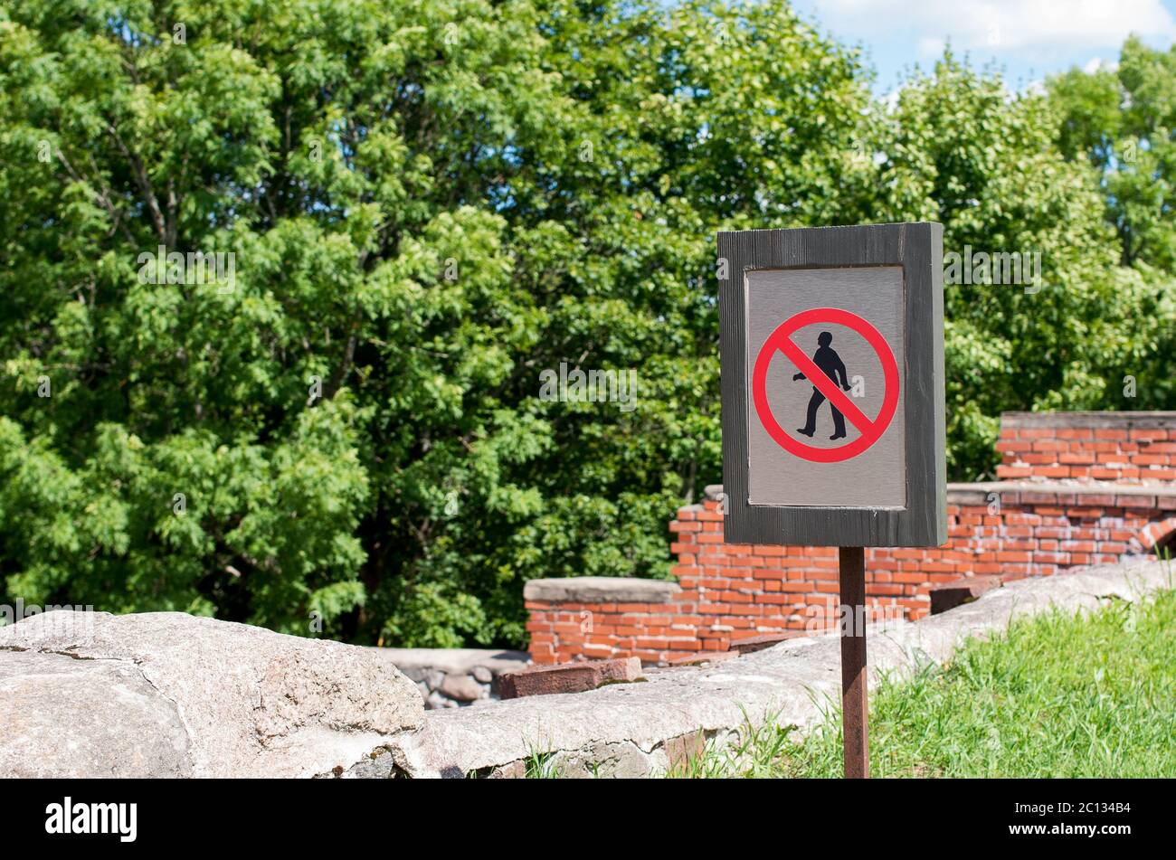 Unrecognizable persons violating the prohibition to walk. Warning. Stock Photo