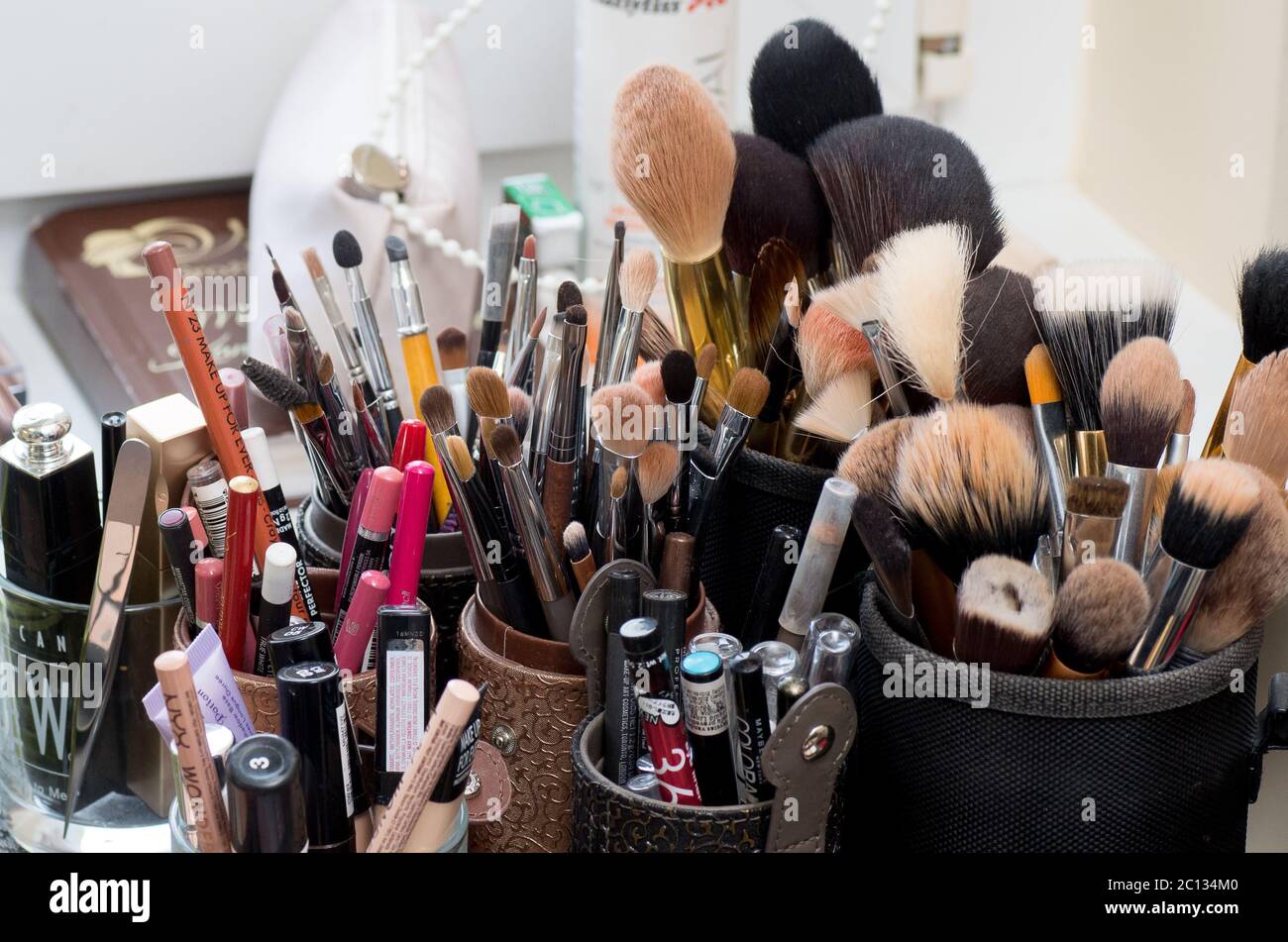 LITHUANIA, MAZEIKIAI - MAY 21, 2016: Used makeup brushes and cosmetics in beauty salon Stock Photo