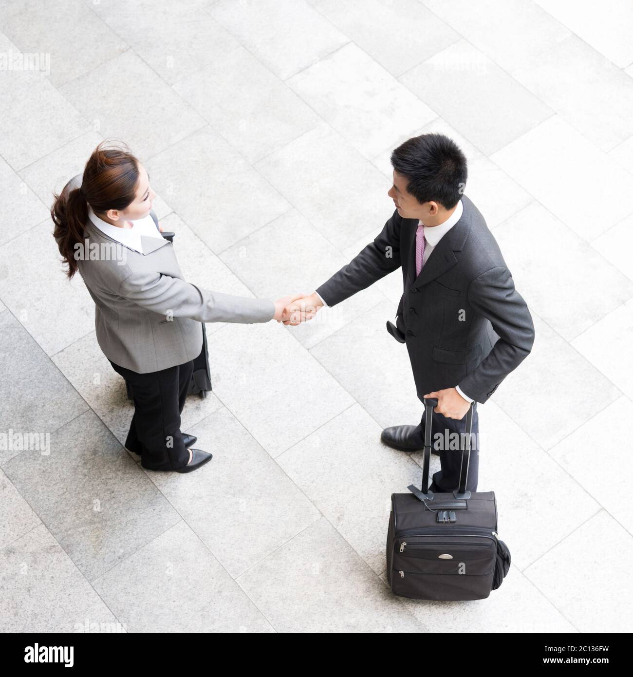 top view of woman is shaking hands with businessman Stock Photo