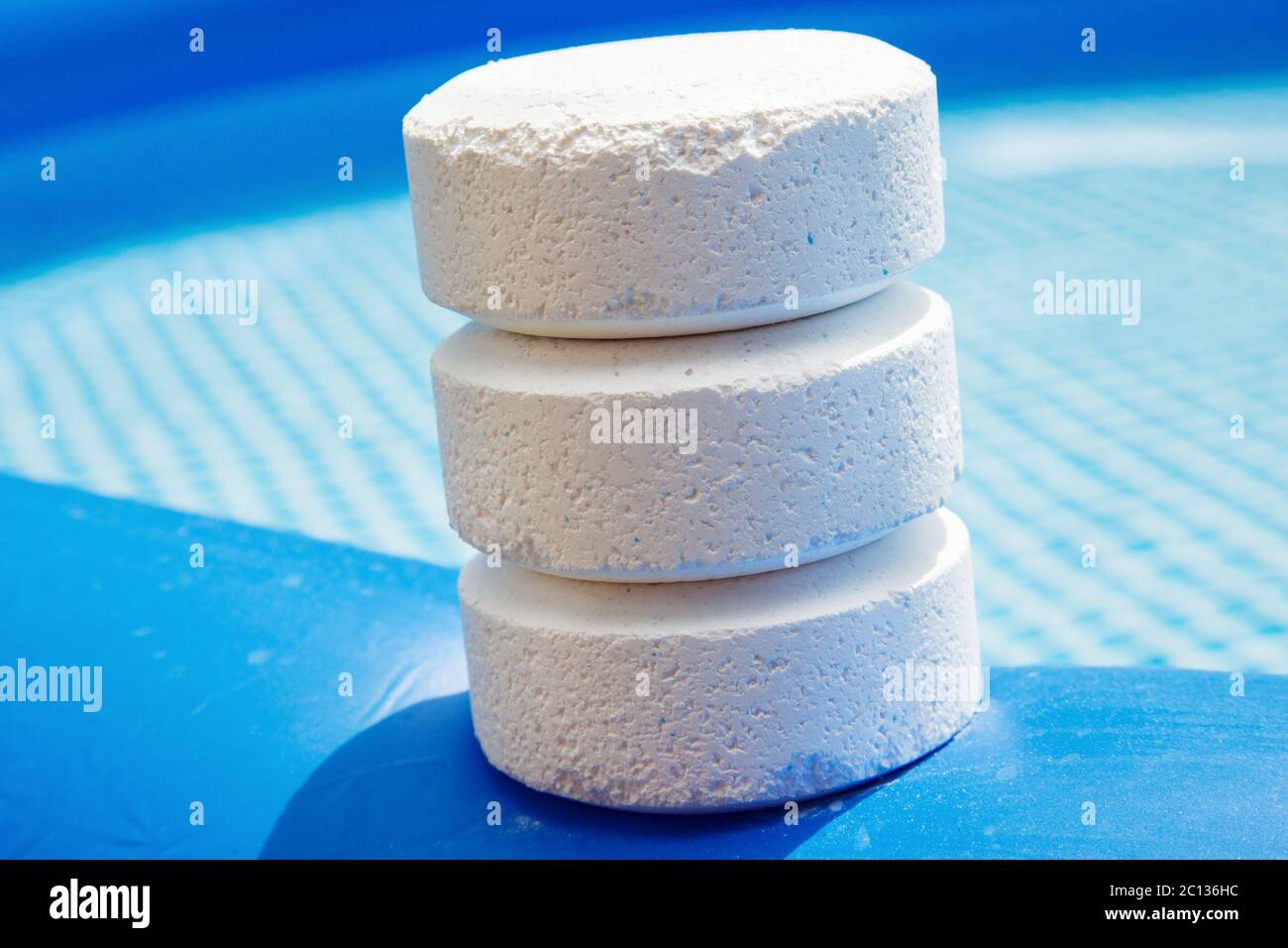 Chlorine Pellets on the edge of an inflatable pool Stock Photo
