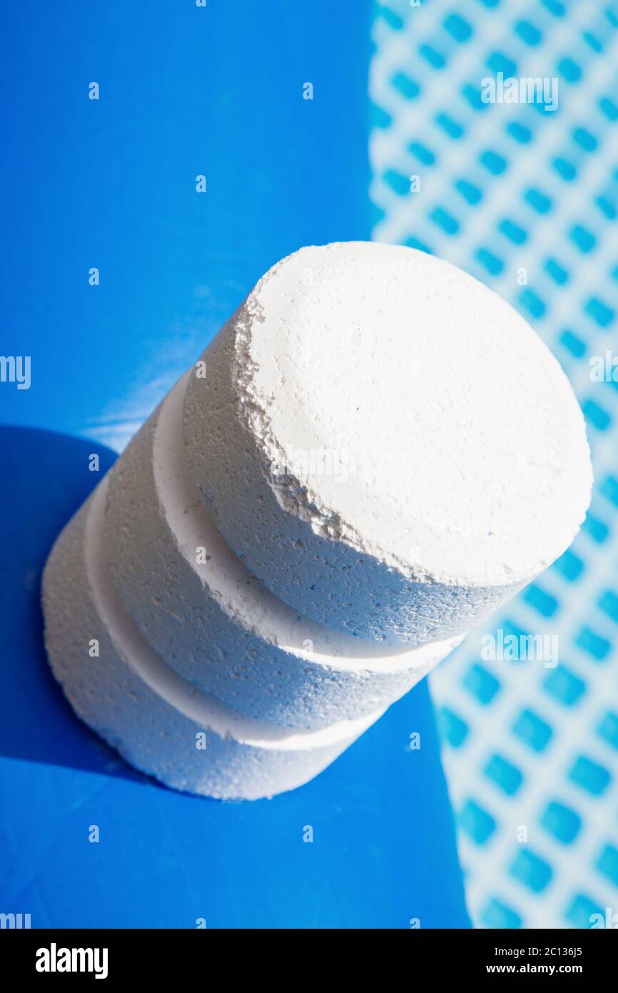 Chlorine Pellets on the edge of an inflatable pool Stock Photo