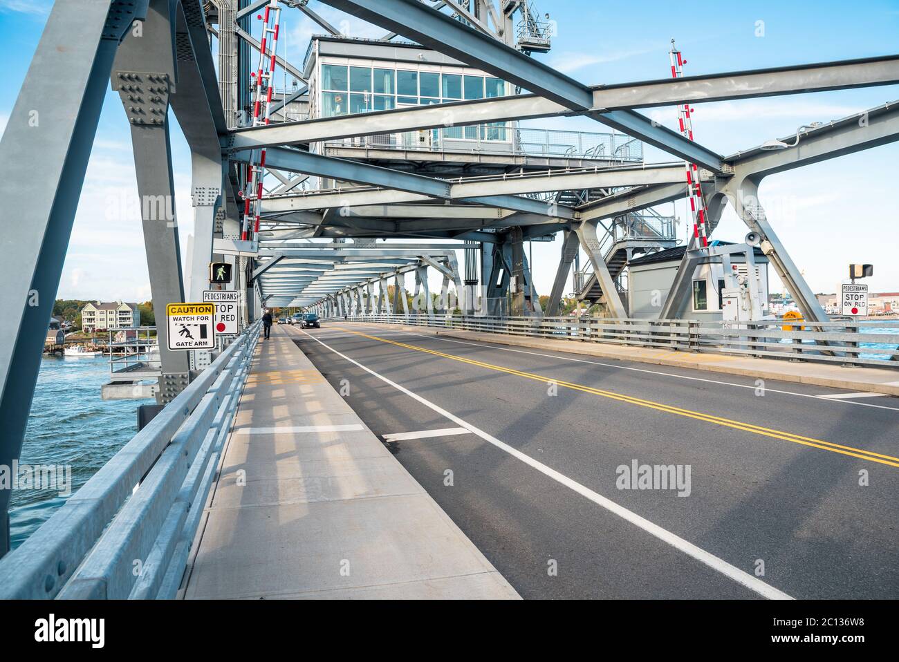 Steel vertical lift road bridge spanning a might river on a clear sutumn day Stock Photo
