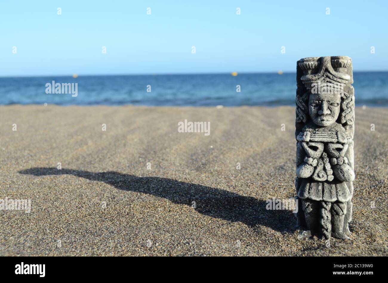 Ancient Maya Statue on the Sand Beach Stock Photo