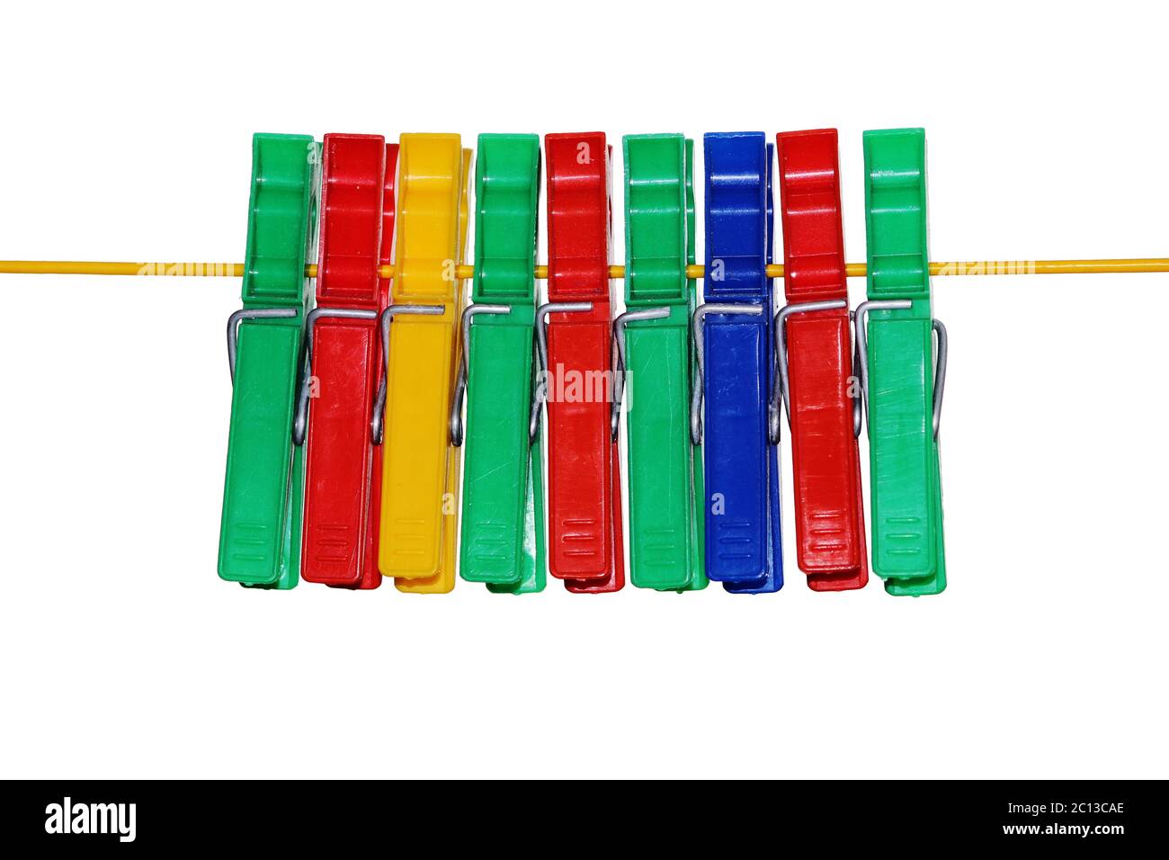 isolated colored plastic clothespins hanging on the rope. Stock Photo