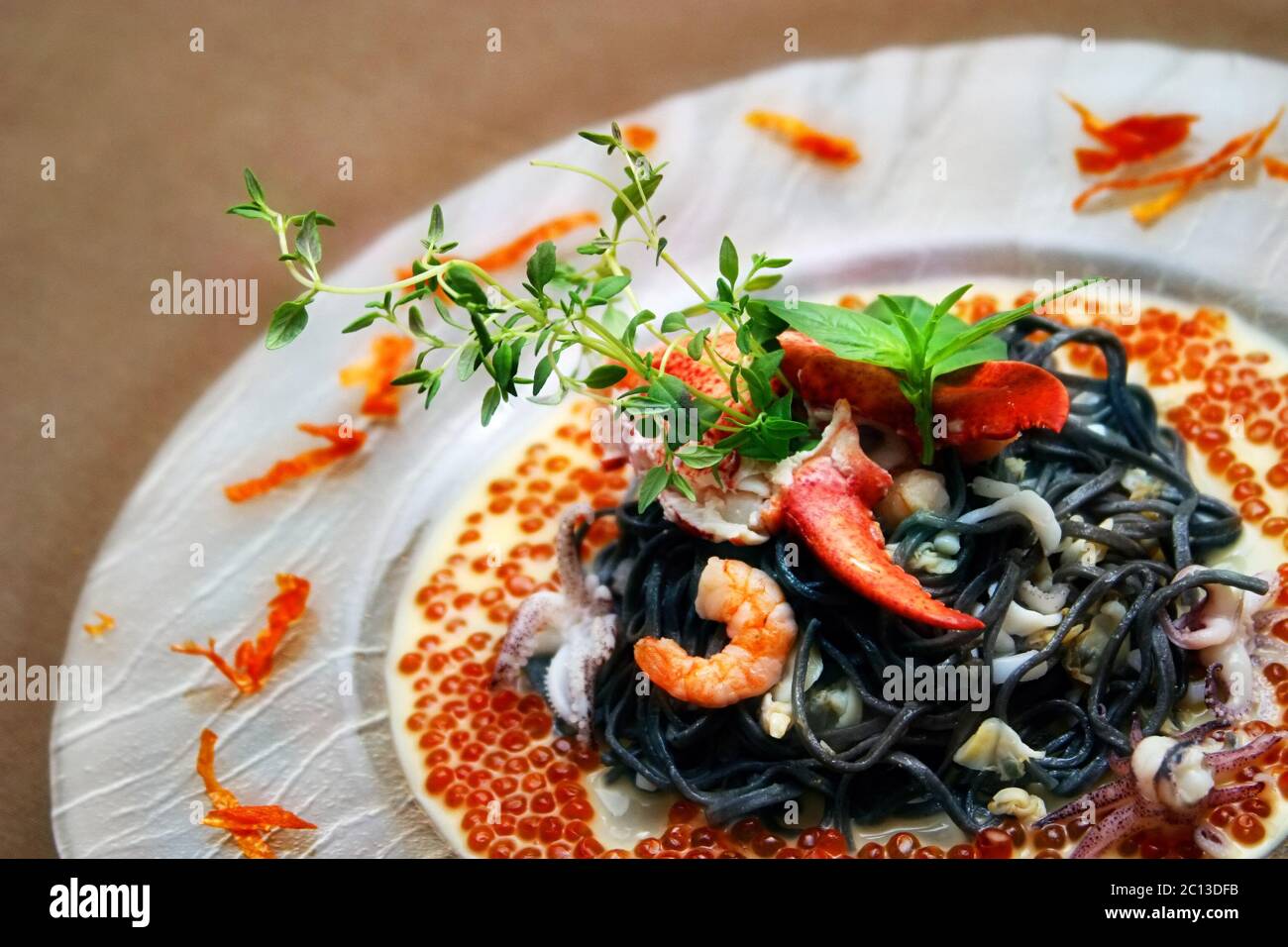 Black pasta with lobster cream sauce and caviar Stock Photo Alamy