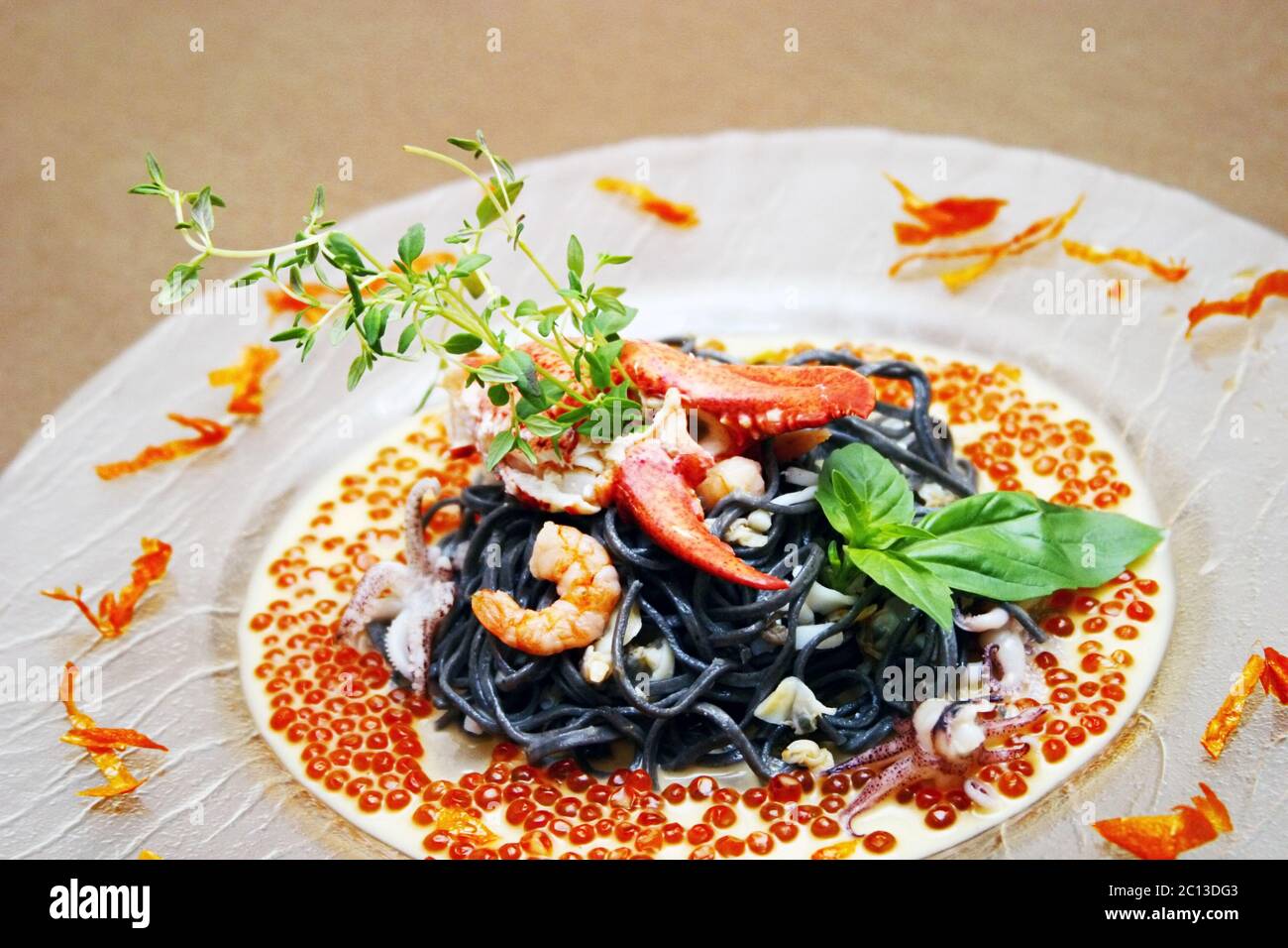 Black pasta with lobster cream sauce and caviar Stock Photo Alamy