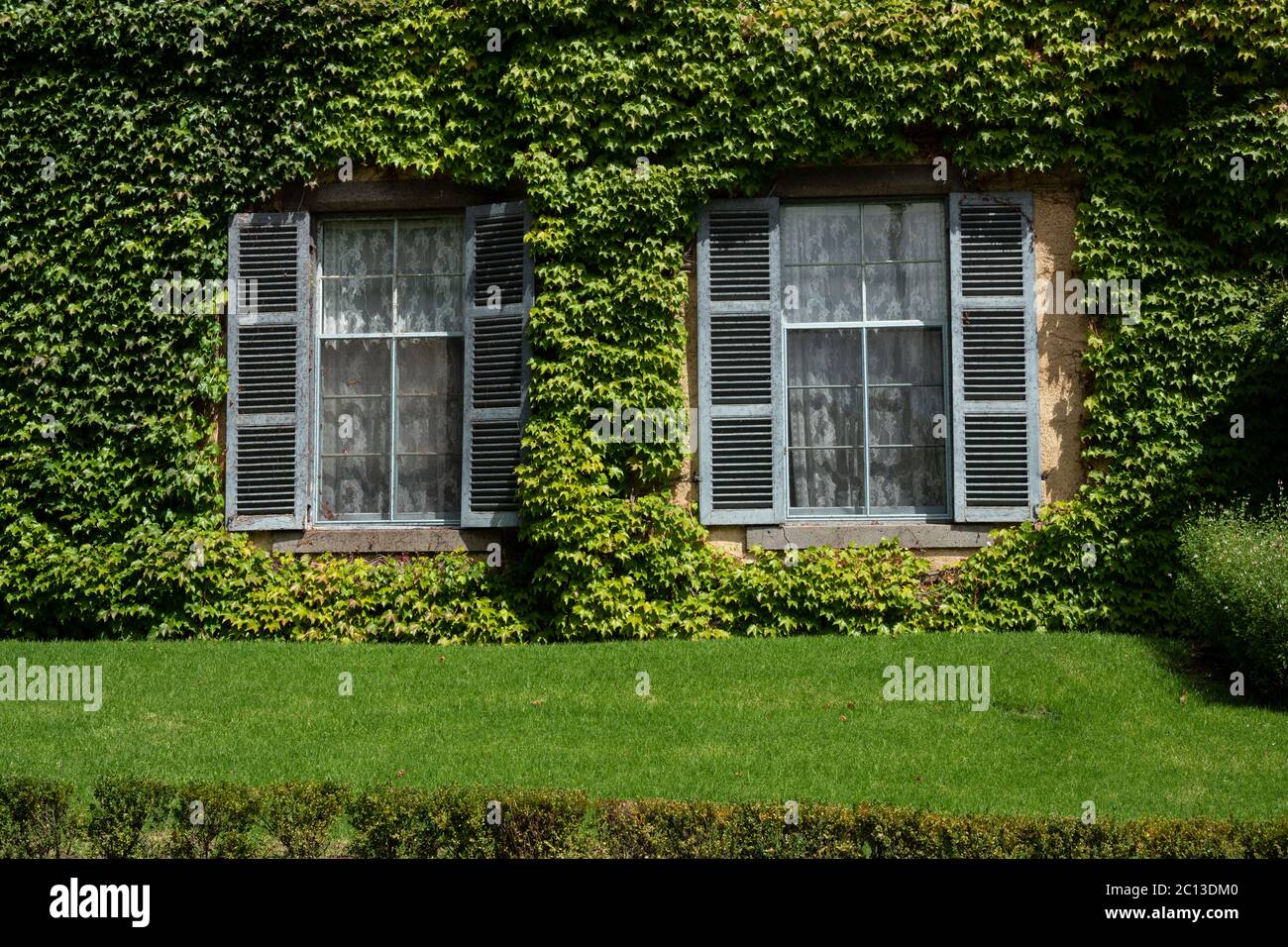 Outside view of Ivy covered and lush garden at Overnewton Castle a heritatge listed property near Melbourne. Stock Photo