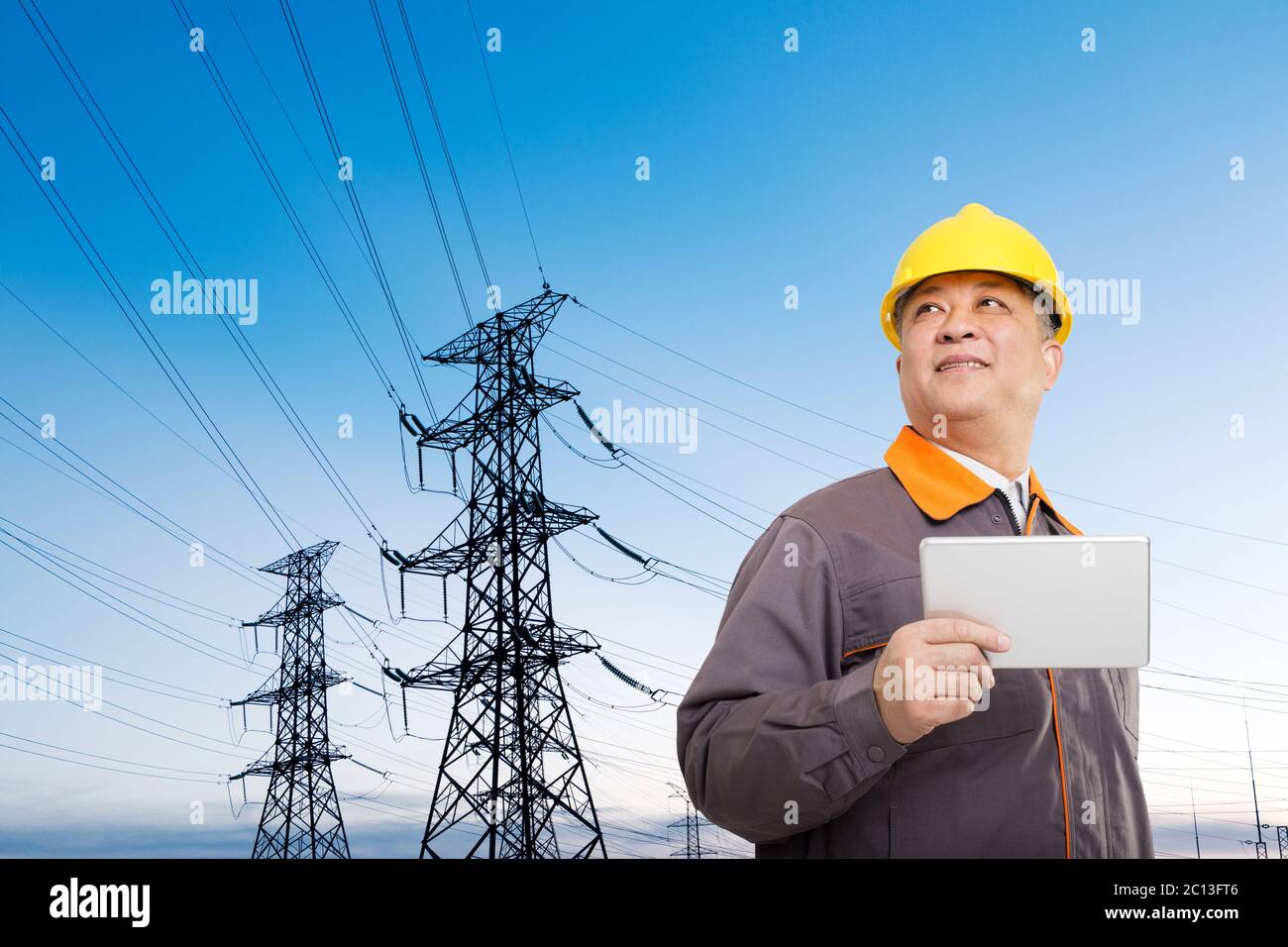 asian old man engineer with tablet and pylons Stock Photo