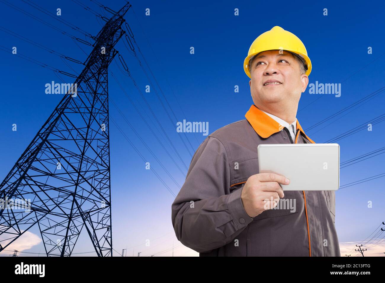 asian old man engineer with tablet and pylons Stock Photo