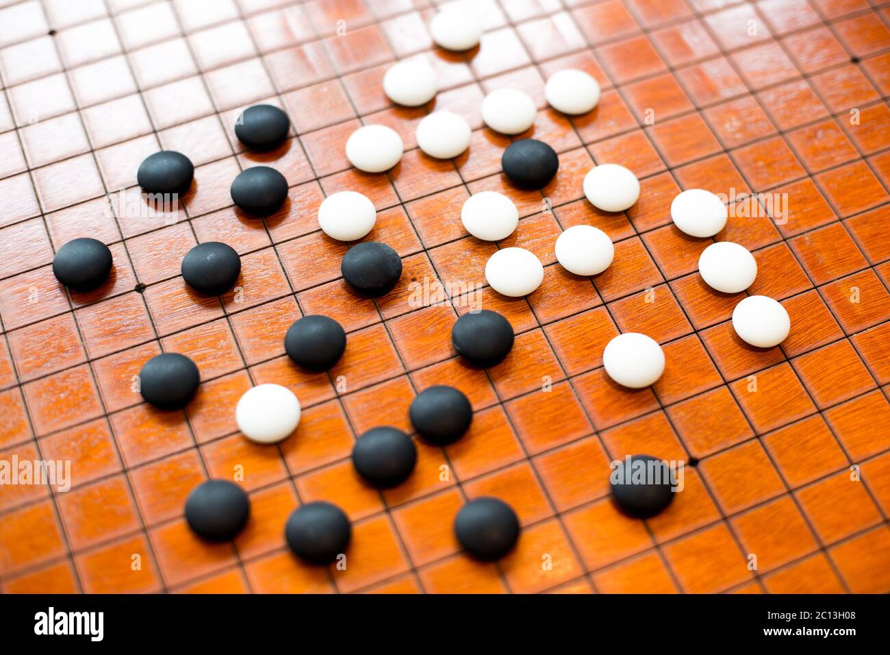 black and white stones on go board Stock Photo Alamy
