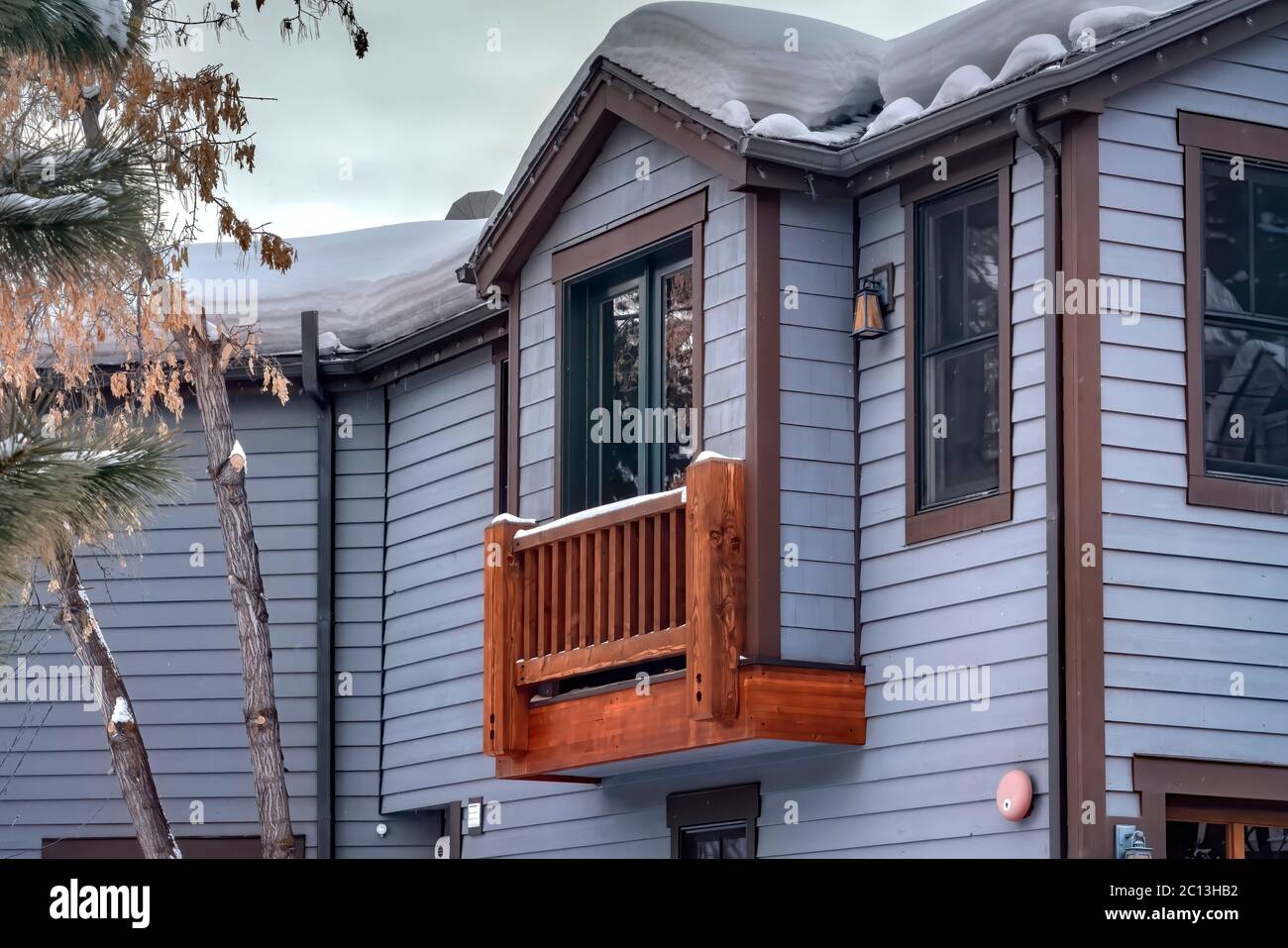 Box bay window of home with gable roof sliding door and wooden railing Stock Photo Alamy