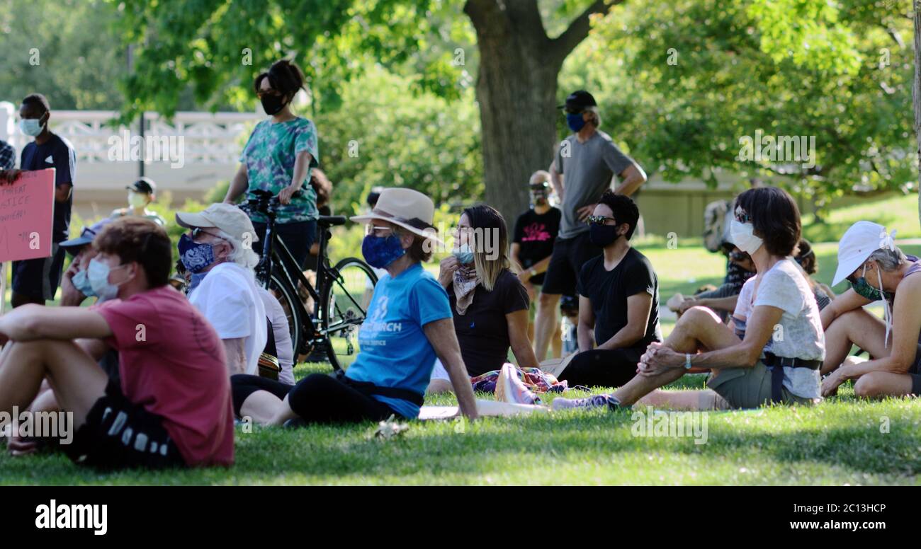 Black Lives Matter protestors wearing face masks at Boulder's Central Park listen to speakers before a demonstration in downtown Boulder. Stock Photo
