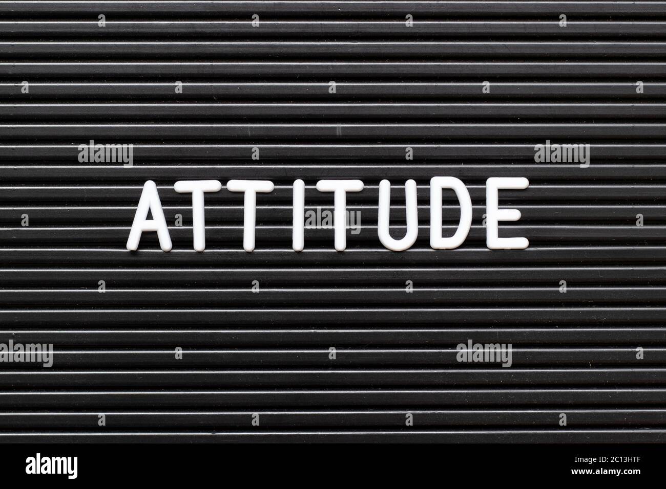 Black felt board with white alphabet in word attitude background ...