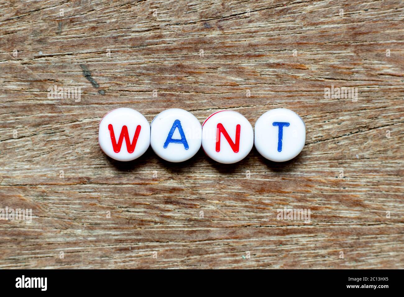 White bead with color letter in word want on wood background Stock ...