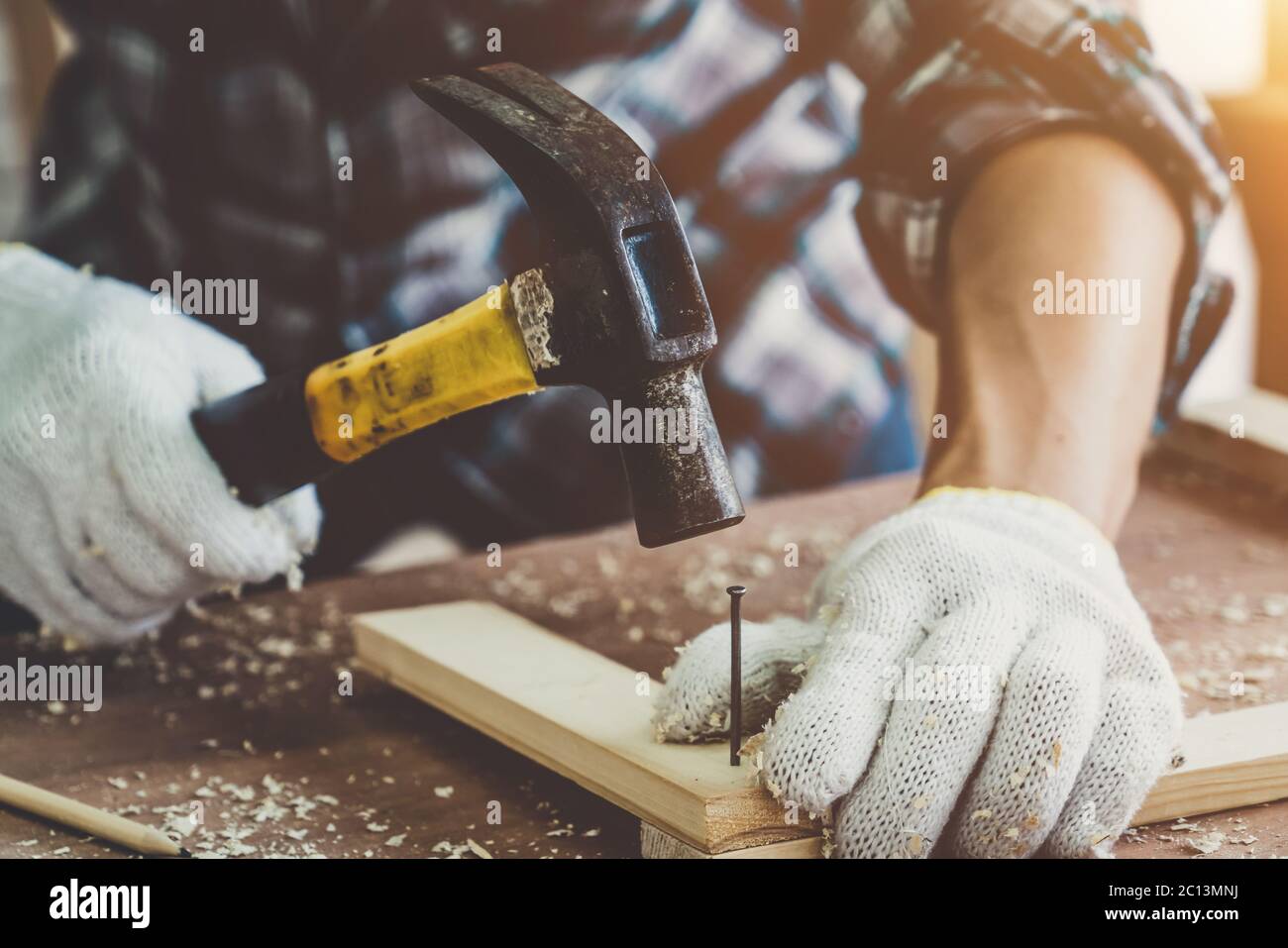 Carpenter working on wood craft at to produce construction