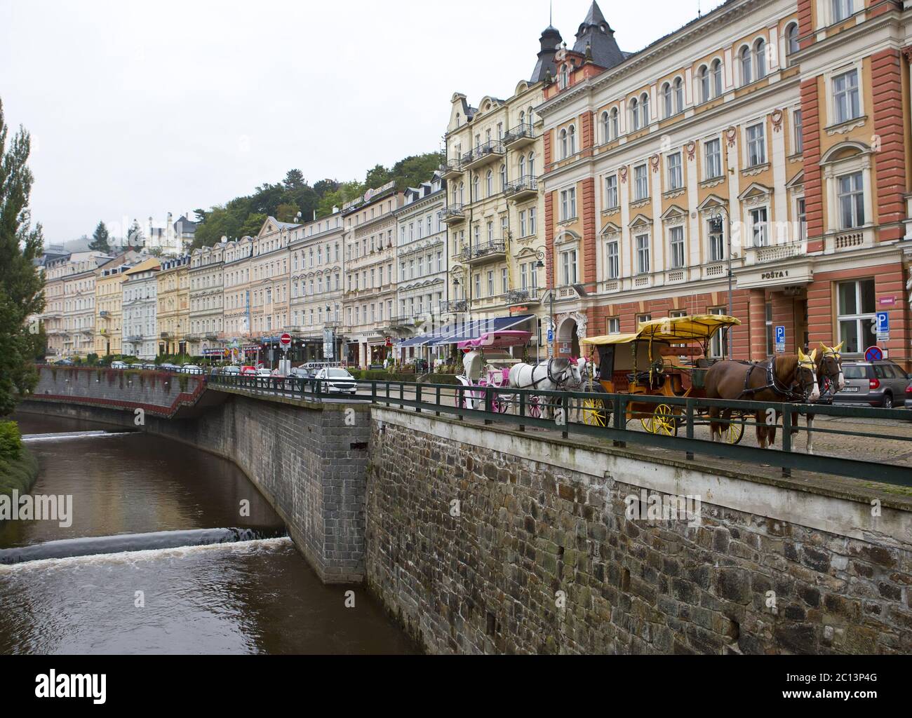 tourists walk along the Tepla river on September 14, 2014 in Karlovy Vary, Czech Republic Stock Photo