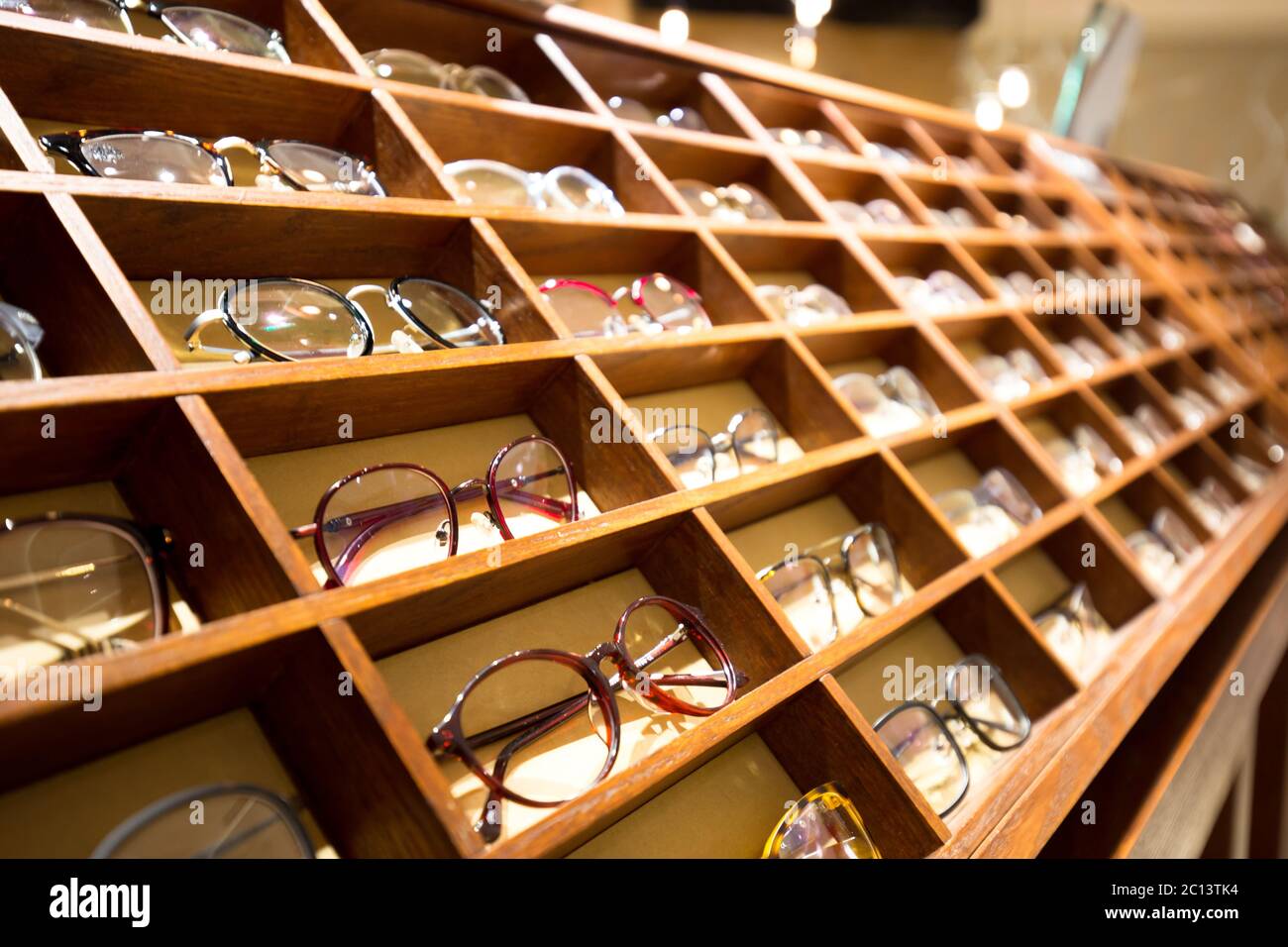 eyeglasses in wooden rack Stock Photo - Alamy