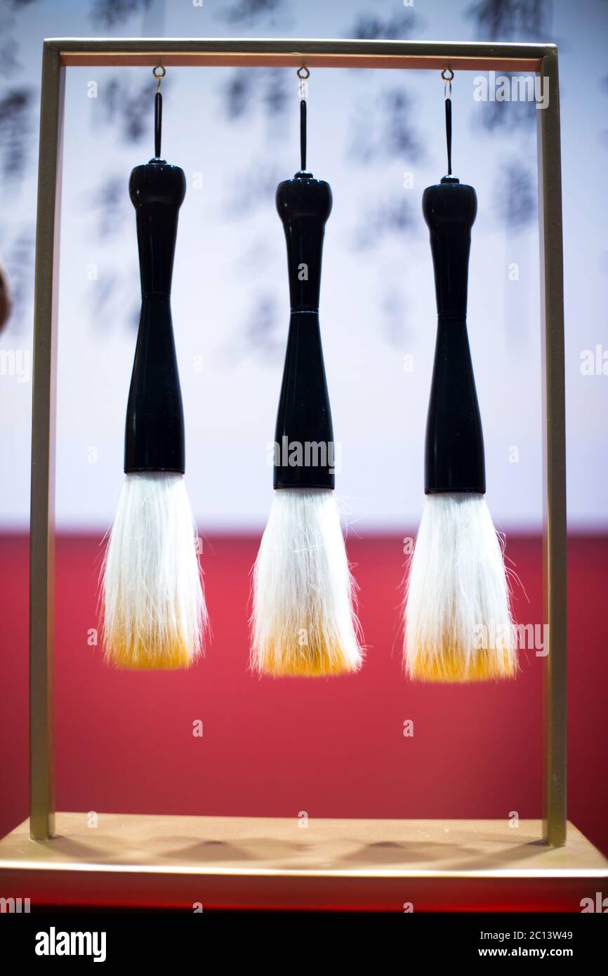 hanging calligraphy brushes on steel frame Stock Photo
