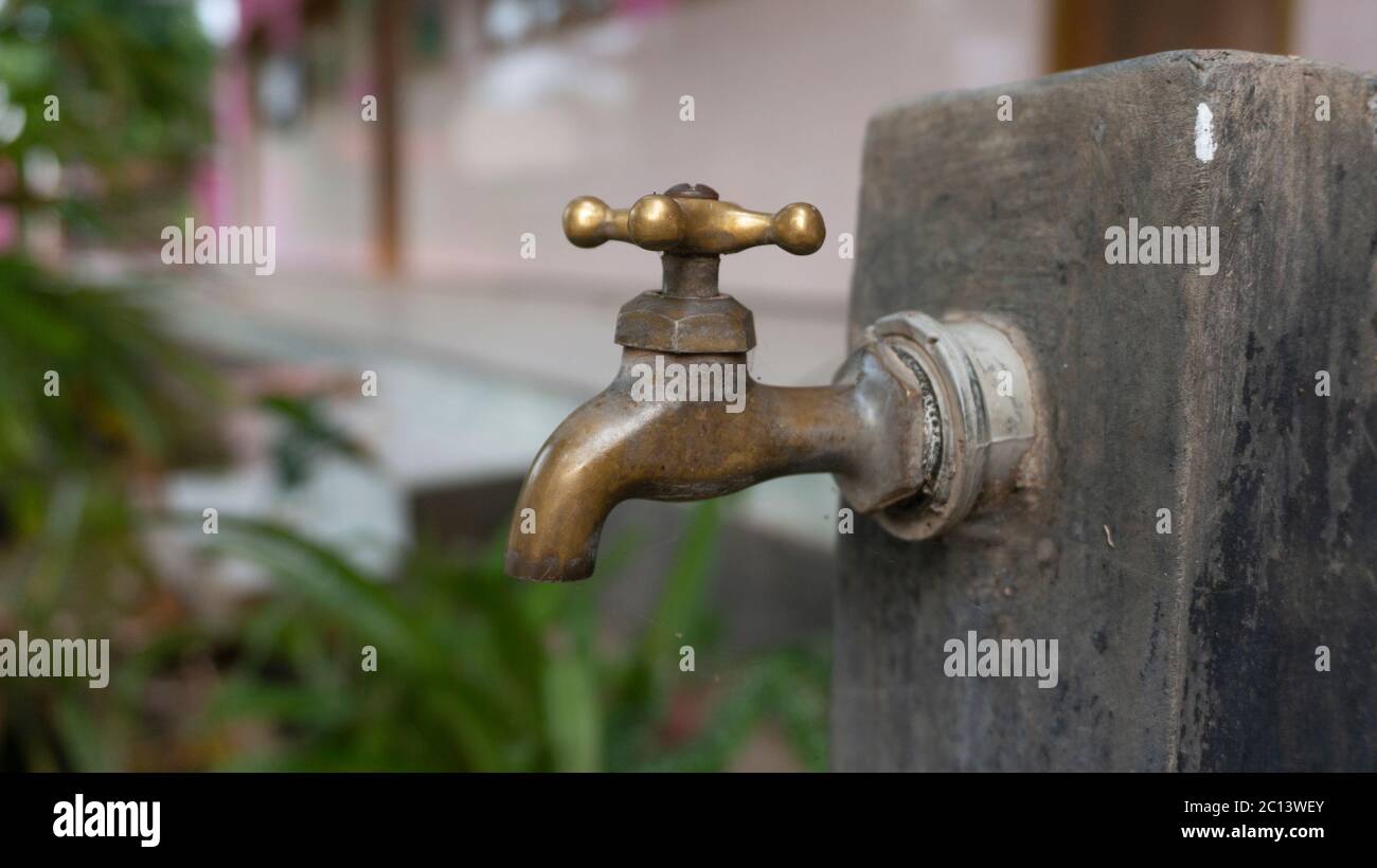 Brass water tap in a school. washing your hands with soap regularly can