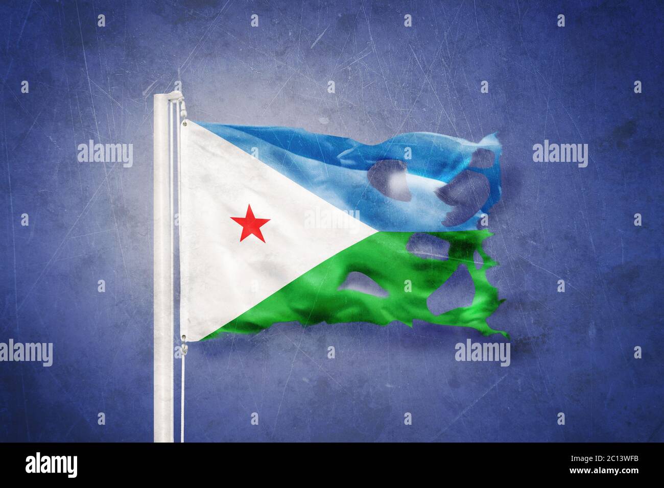 Torn flag of Djibouti flying against grunge background Stock Photo