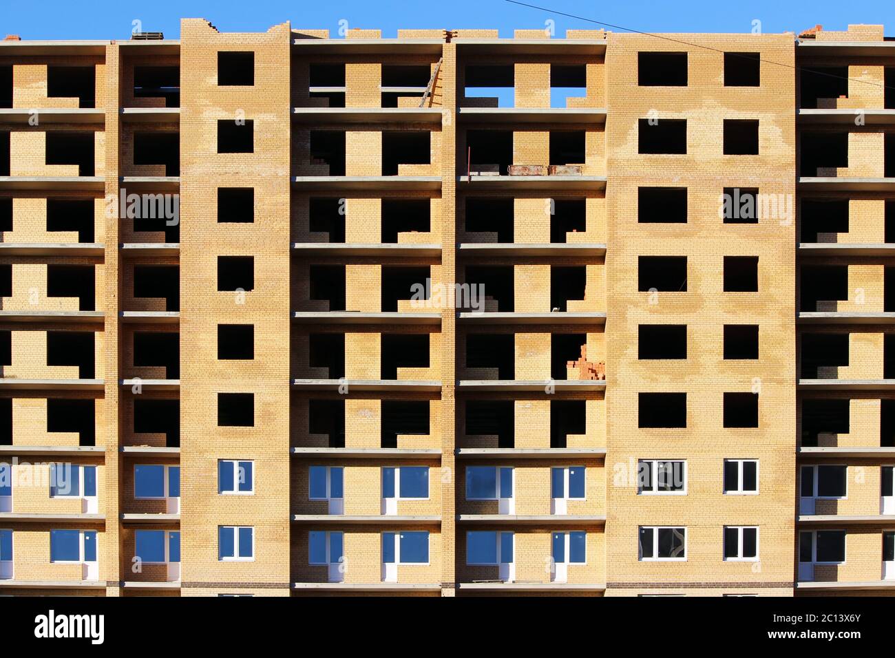 unfinished brick house on a background of blue sky Stock Photo - Alamy