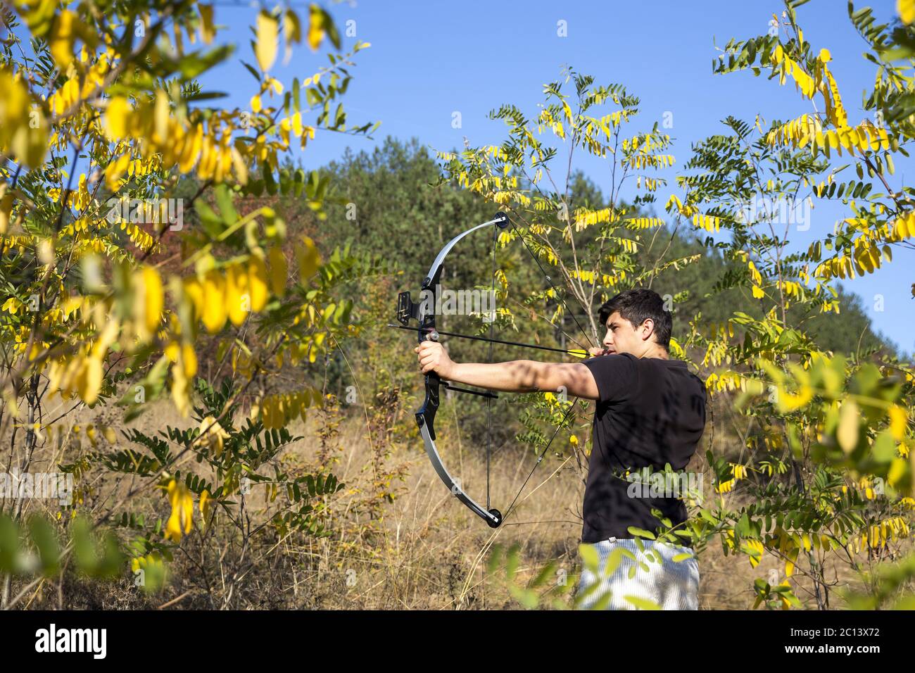 Archer draws his compound bow Stock Photo Alamy