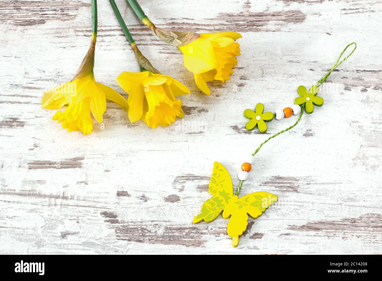 jonquils with wooden butterfly Stock Photo