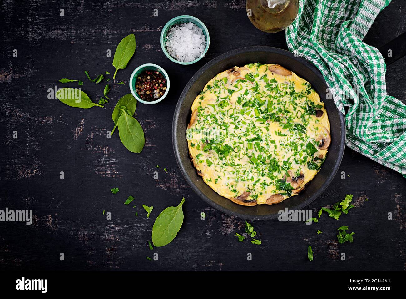 Spinach and mushroom omelette. Frittata made of eggs, mushrooms and