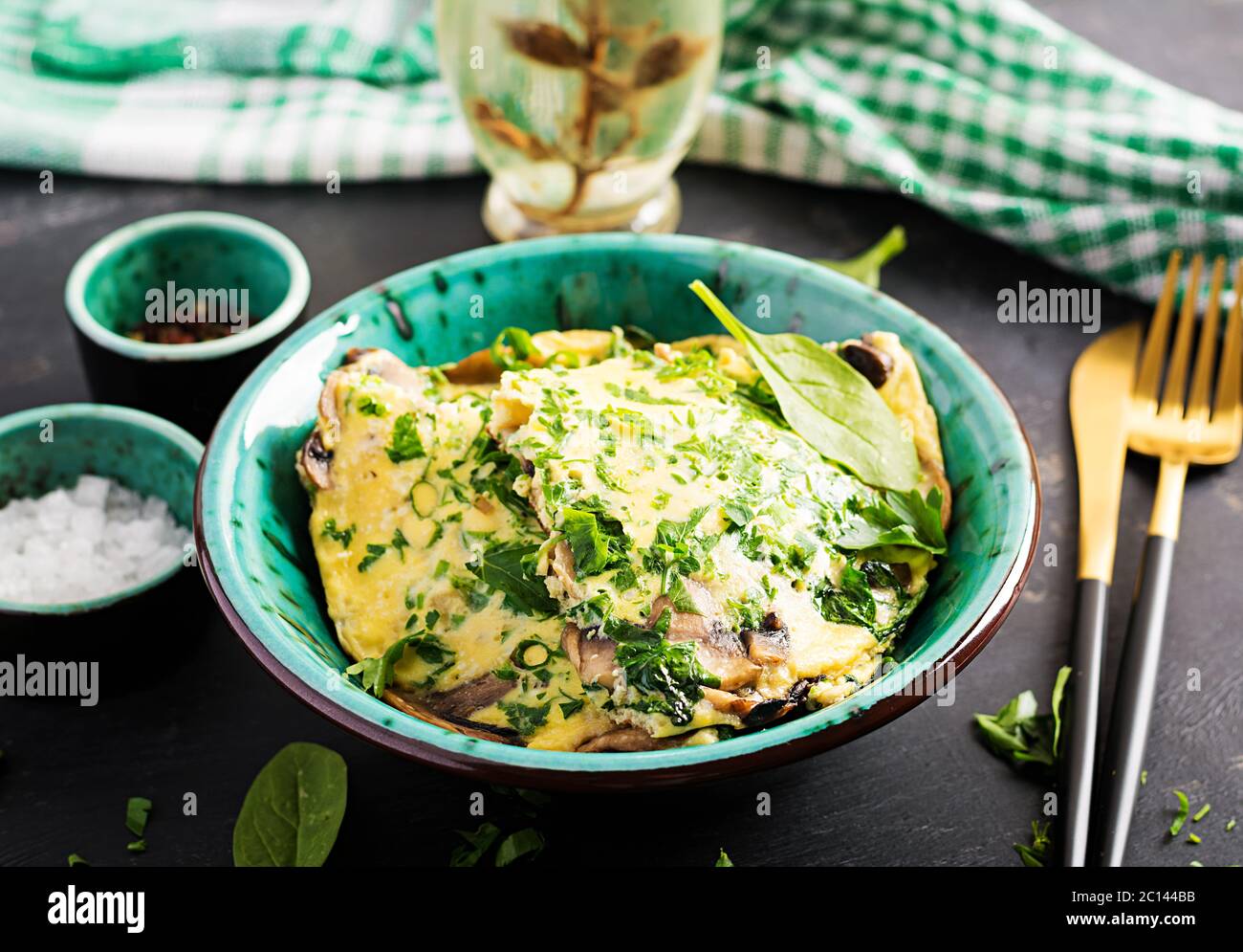 Spinach and mushroom omelette. Frittata made of eggs, mushrooms and