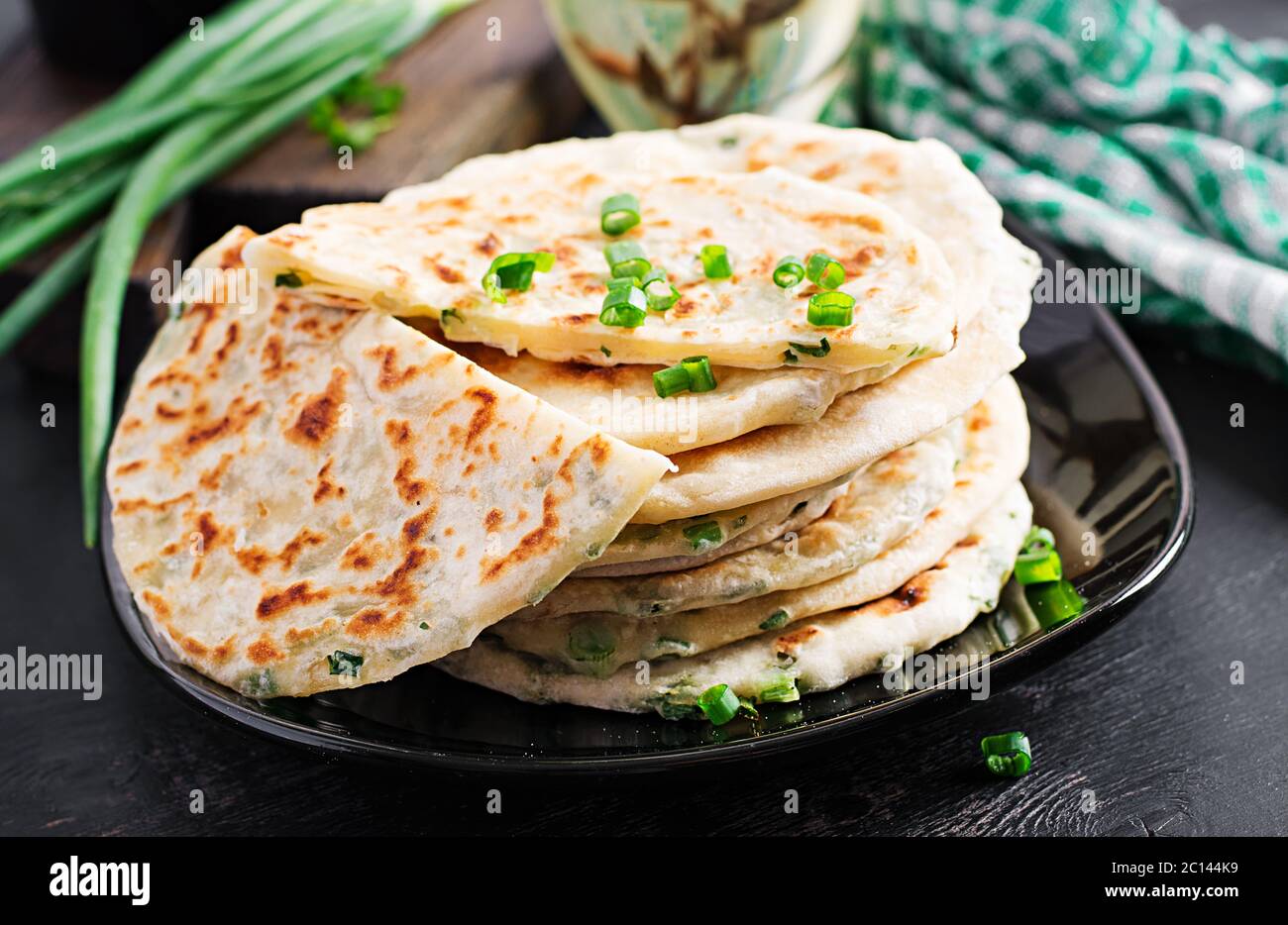 Traditional indian bread. Pita bread with green onions. Onion naan