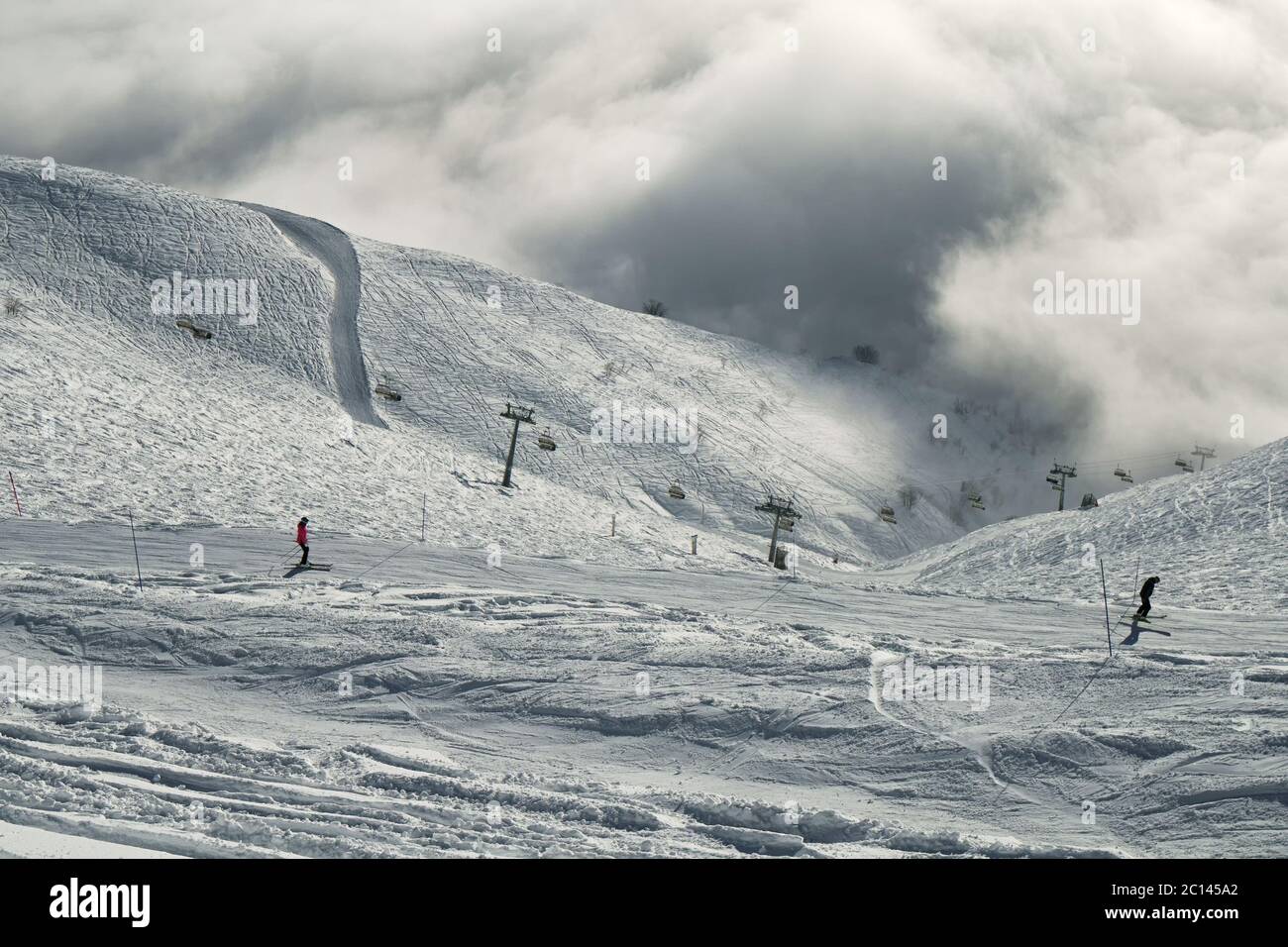 Ski slopes in the clouds on southern slope Aibga Ridge of Western Caucasus at Rosa Khutor Alpine Resort Stock Photo