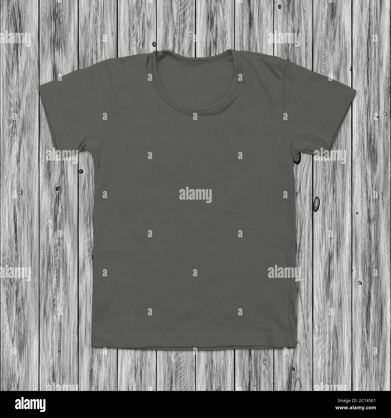 Grey blank t-shirt on dark wood background Stock Photo
