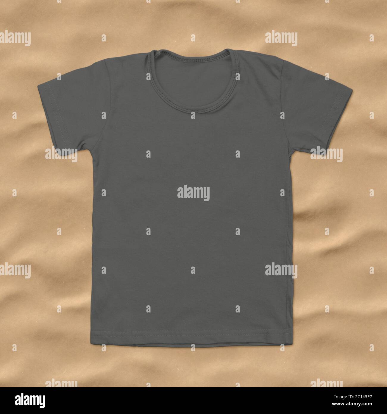 Grey blank t-shirt on dark sand background Stock Photo