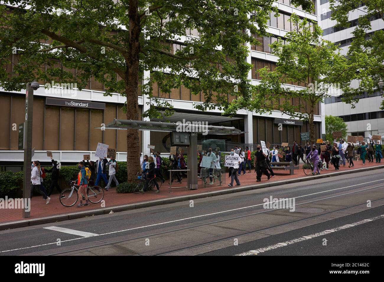A group of BLM demonstrators, mostly young medical workers and PA students, march along the 6th Ave in downtown Portland, Ore., on Sat., Jun 13, 2020. Stock Photo