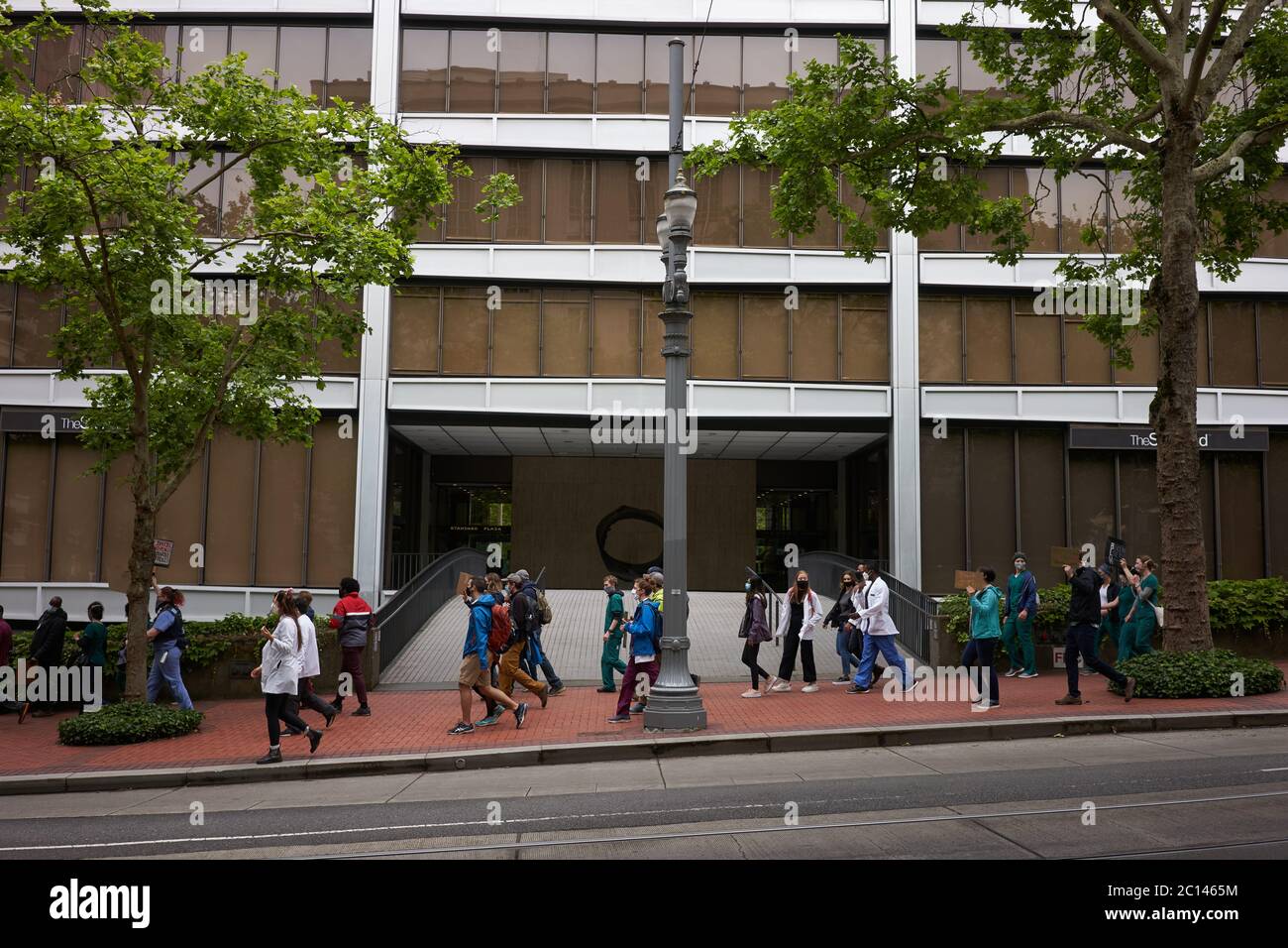 A group of BLM demonstrators, mostly young medical workers and PA students, march along the 6th Ave in downtown Portland, Ore., on Sat., Jun 13, 2020. Stock Photo