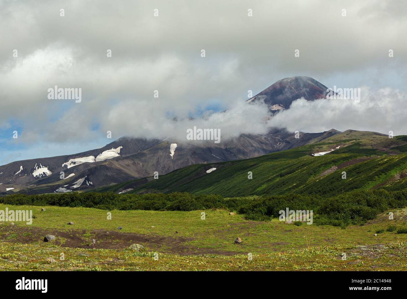 Avacha Volcano or Avachinskaya Sopka in the clouds on Kamchatka Peninsula Stock Photo