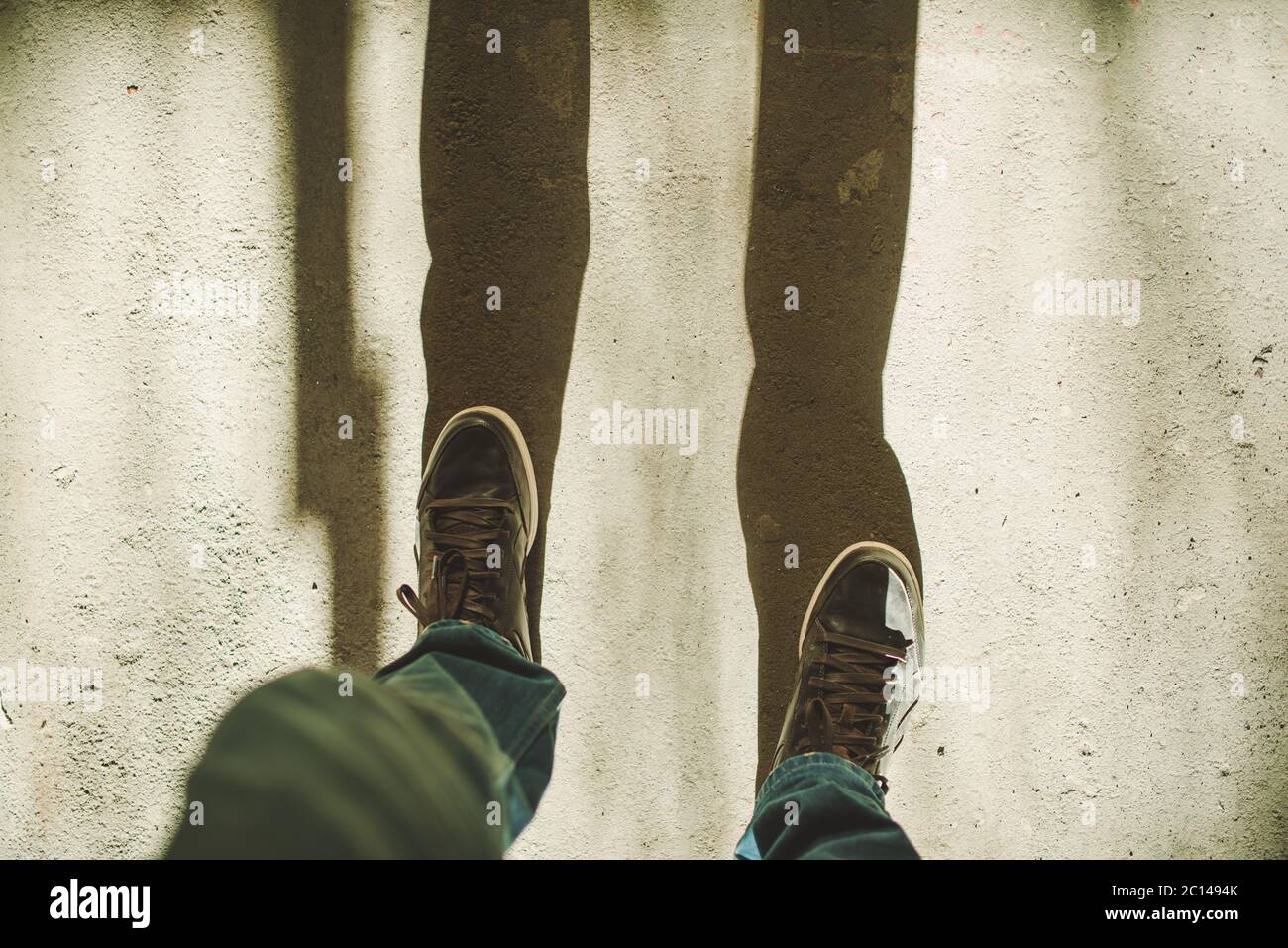 Two feet in brown shoes over concrete, first person view with bright sun  shadows Stock Photo - Alamy