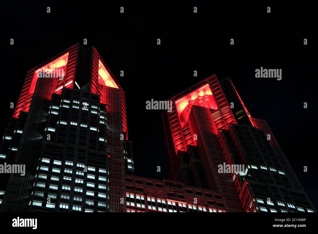 Tokyo metropolitan government building is lit up in red signifying “Tokyo alert” warning an additional caution against COVID-19 infections on 10 June. Stock Photo