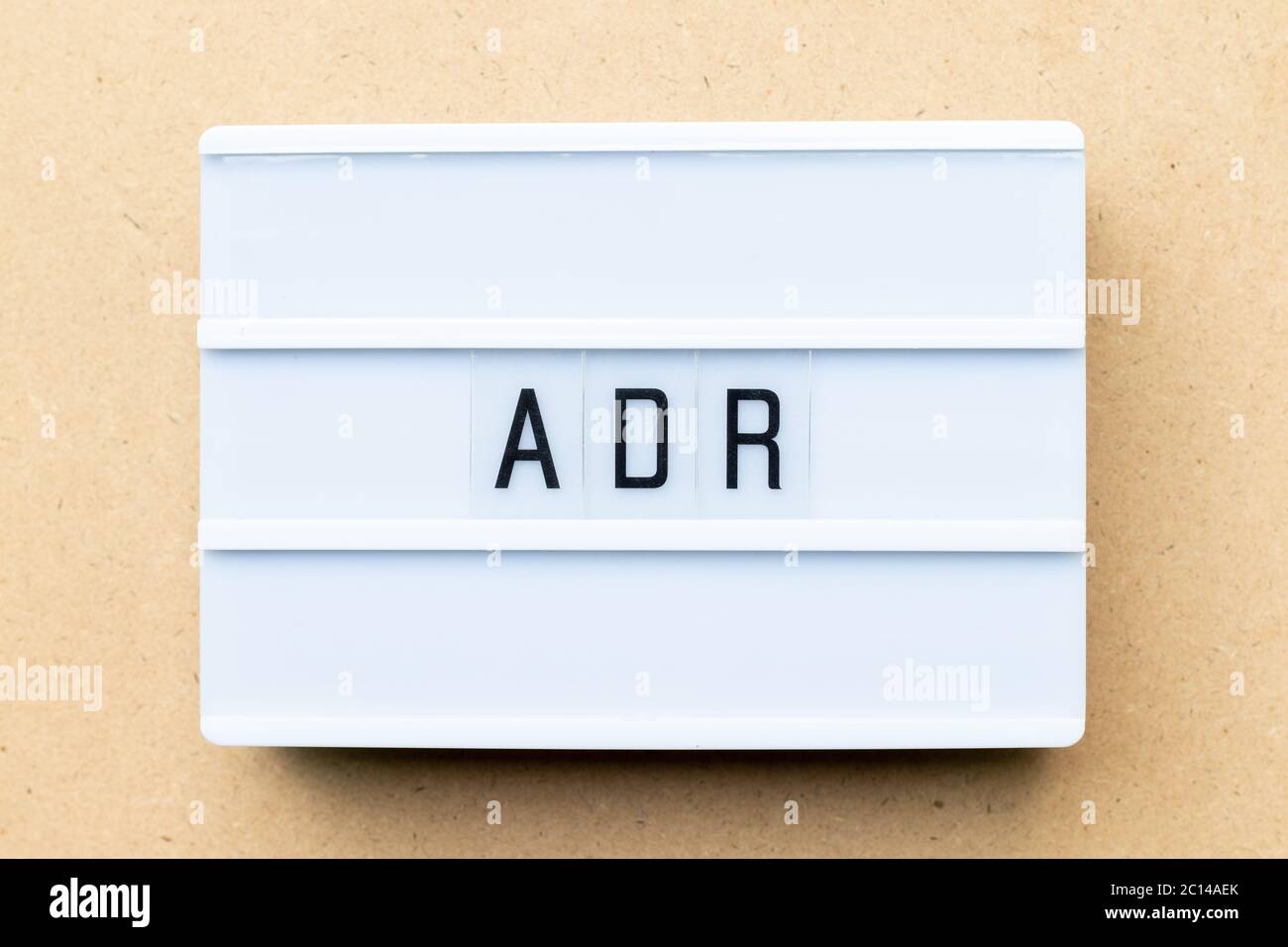 White lightbox with word ADR (Abbreviation of Adverse drug reaction) on wood background Stock Photo