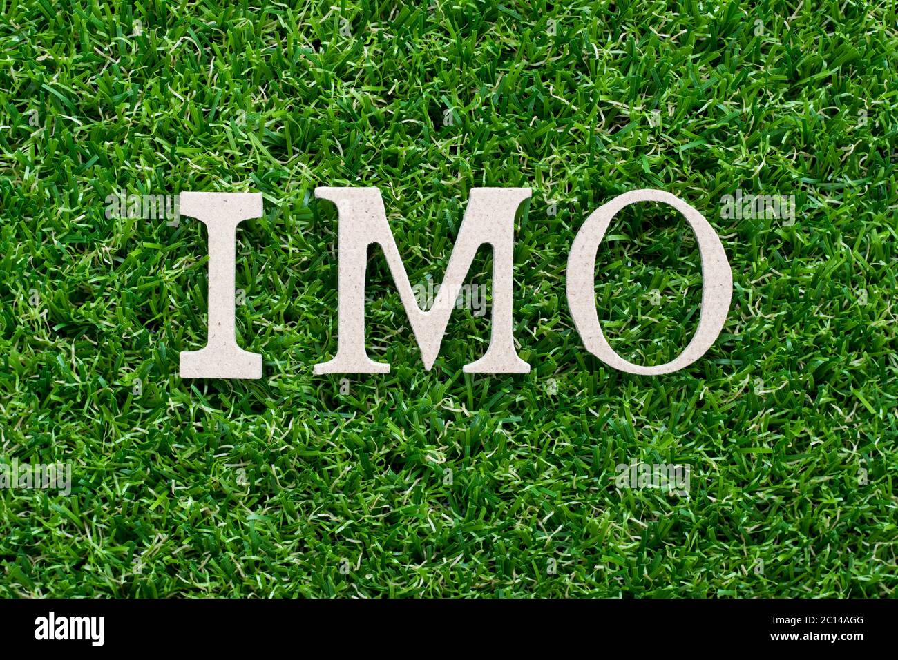 Wood alphabet in word IMO (abbreviation of in my opinion) on artificial