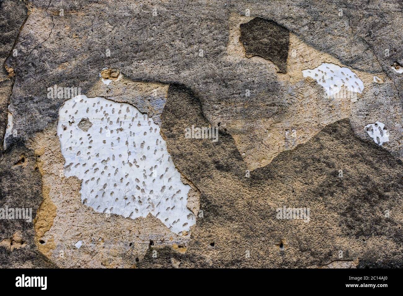 Old and repatched plaster and stonework on old building - France. Stock Photo