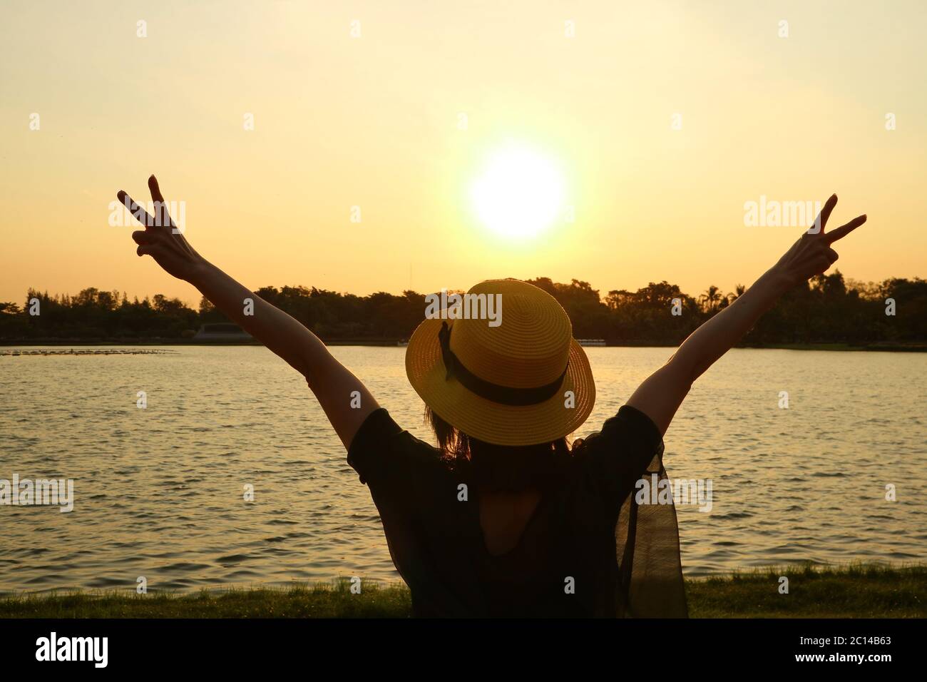 Silhouette of a woman raising arms happy with beautiful sunrise Stock ...
